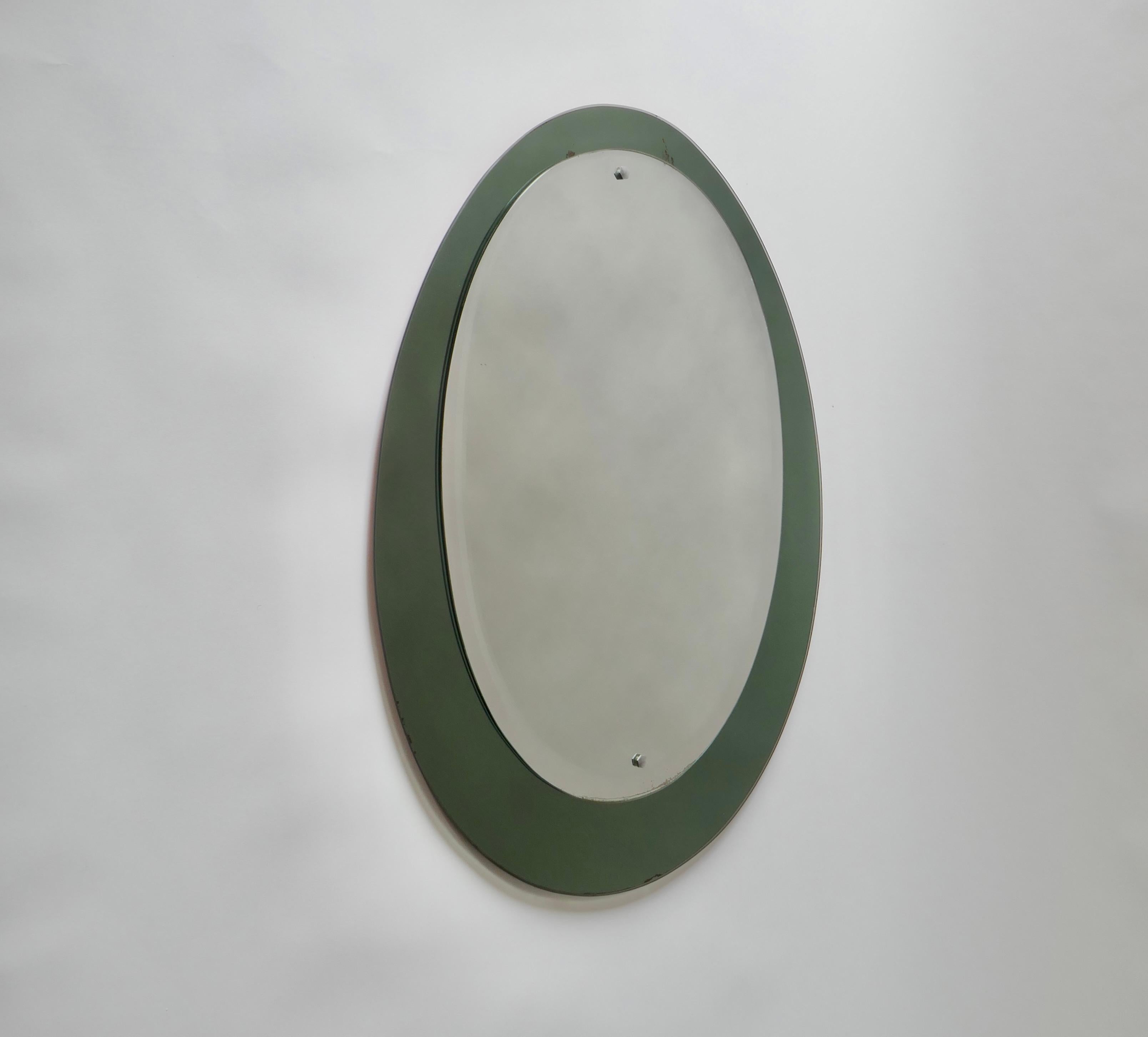 Mid-century oval mirror with a green smoked mirrored frame, 
Italy 
1960s.