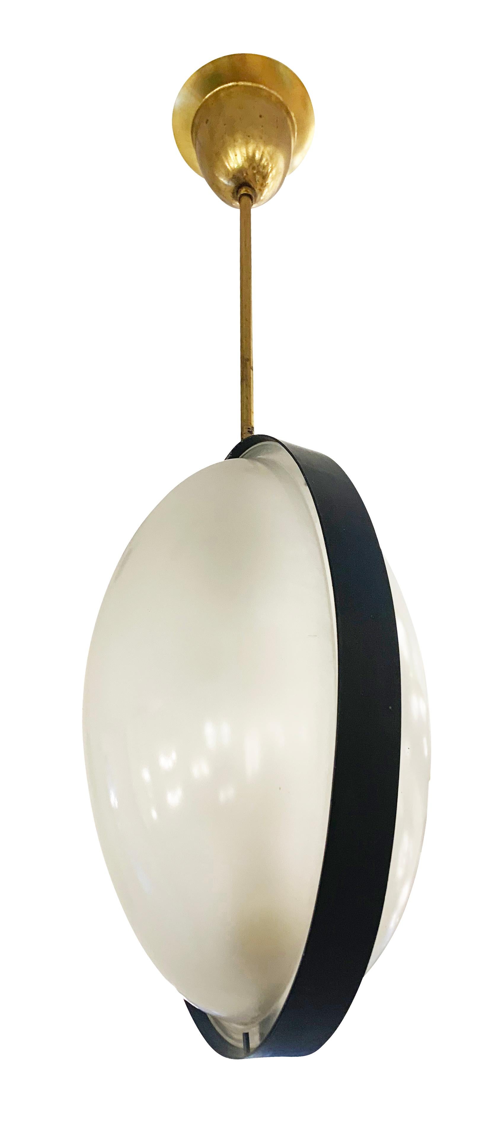 Italian Mid-Century oval pendant with two frosted glass diffusers divided by a black lacquered frame. Brass stem and canopy. Holds two light sources. Height of stem can be adjusted as needed.

Condition: Excellent vintage condition, minor wear