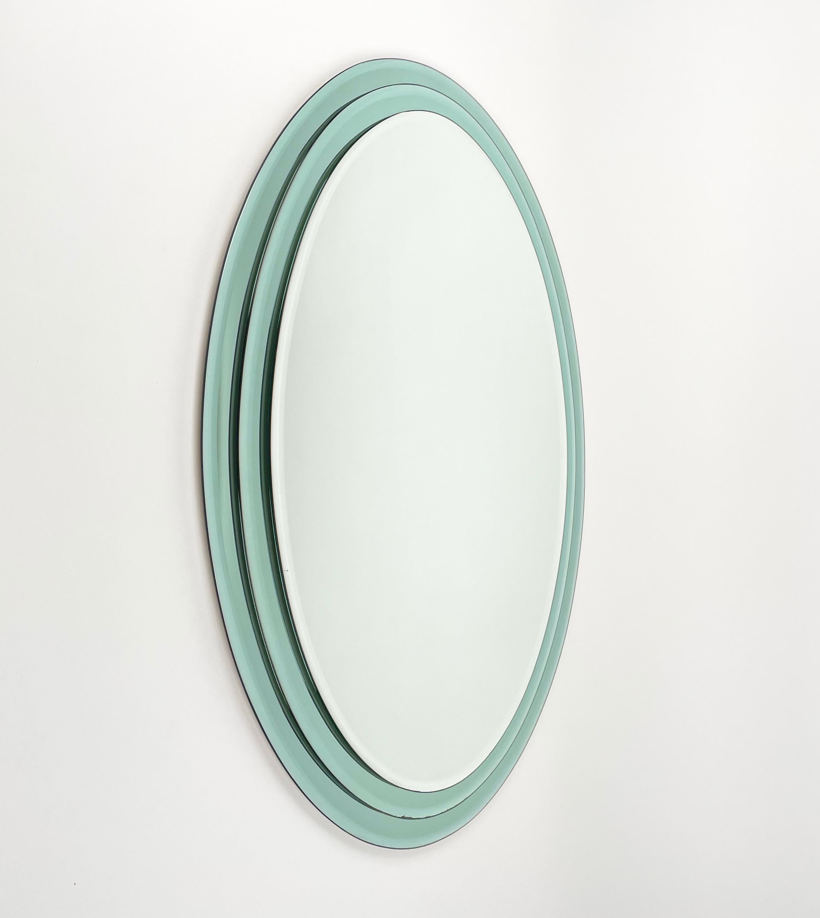 Oval wall mirror featuring three levels green mirror frame in the style of Fontana Arte, Italy, 1970s.

 