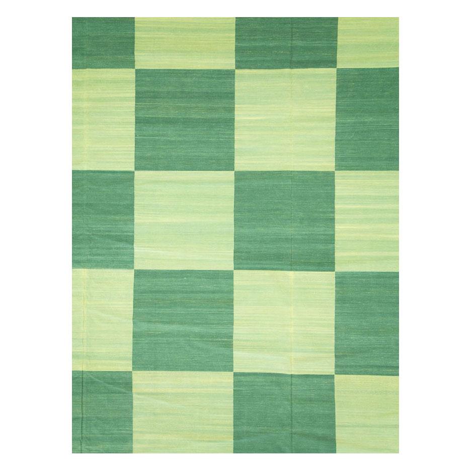 A vintage Indian oversize Dhurrie flat-weave carpet handmade during the mid-20th century. This very large carpet has a checkerboard pattern that is enclosed by a geometric 'S' shaped Greek key border. There are several shades of green to work with