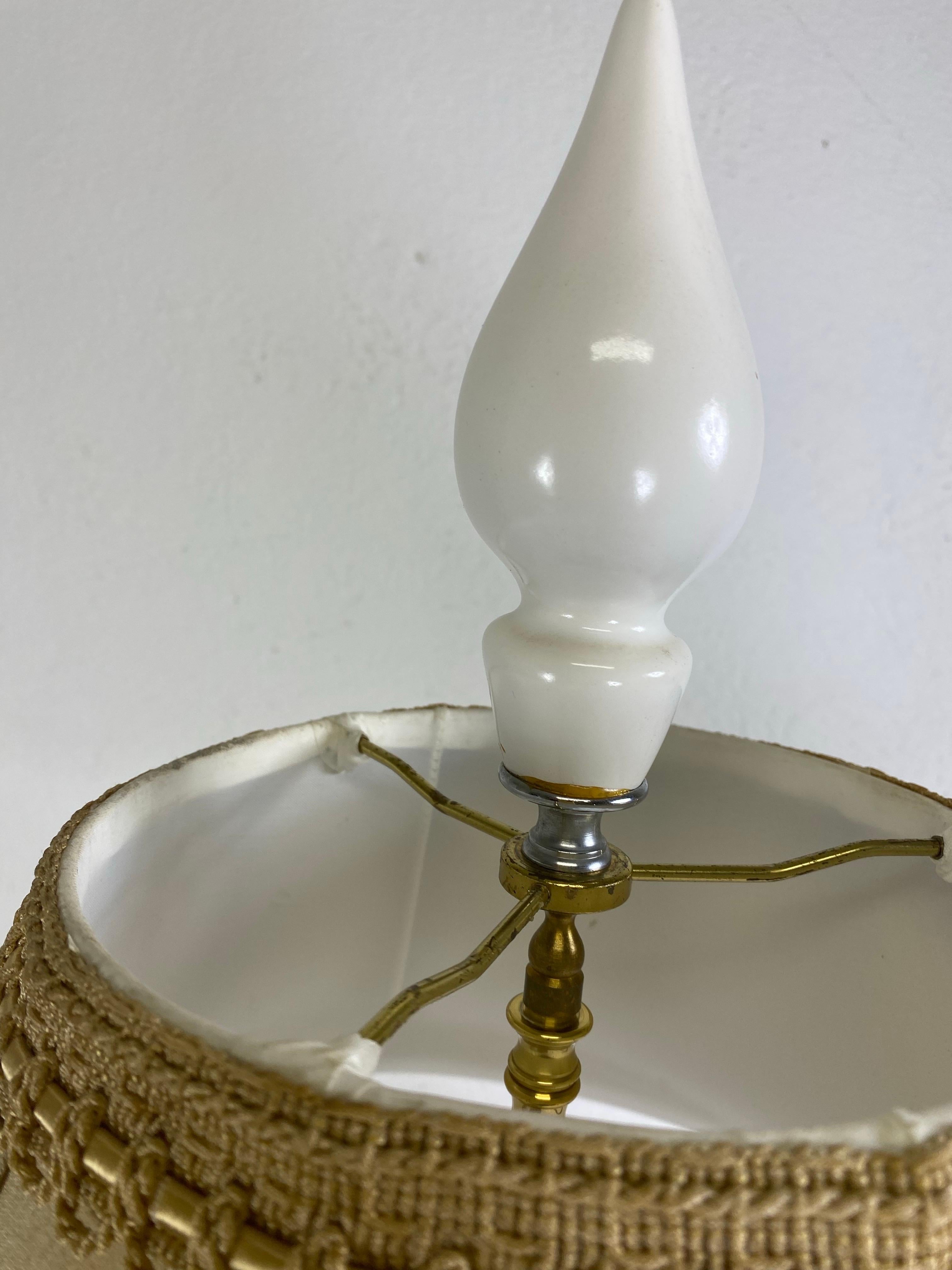 This is a mid-century vintage oversized Blanc de Chin Italian pottery elephant lamp. The lamp features a coolie style handmade silk shade and has its original large stylized finial. This handmade lamp was made in Italy circa 1960.