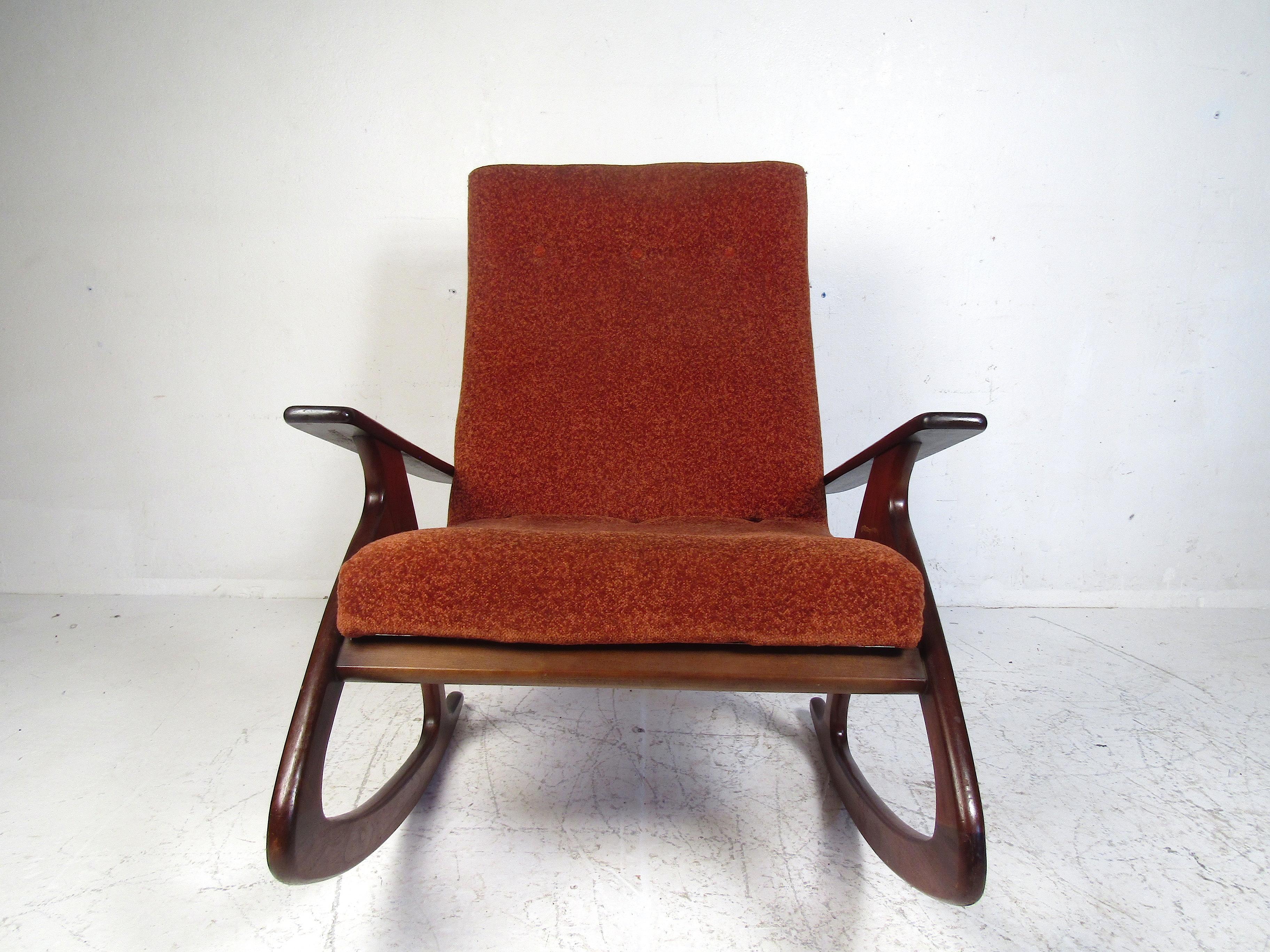 Stylish midcentury oversized rocking chair. Sturdy wooden frame with a smooth rocking action. Spacious seat and wide armrests. Covered in a vintage shag upholstery. Comfortable rocker sure to mesh with any modern interior. Please confirm item