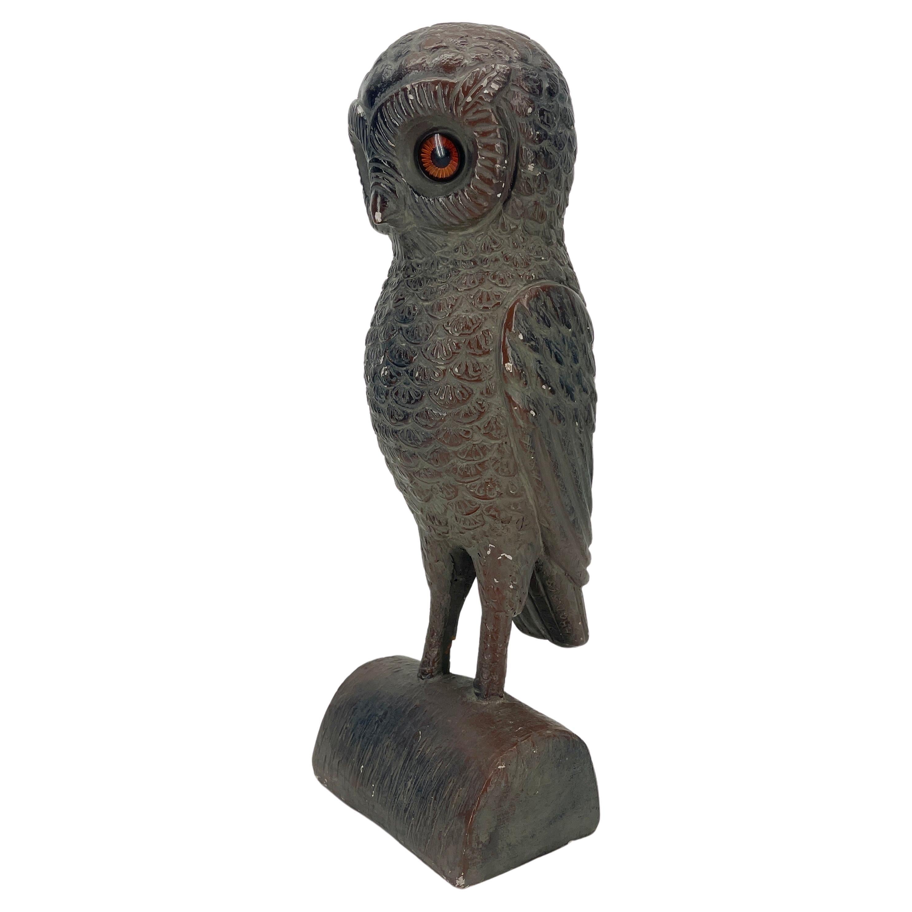 Vintage ceramic owl sculpture on stand with glass eyes.