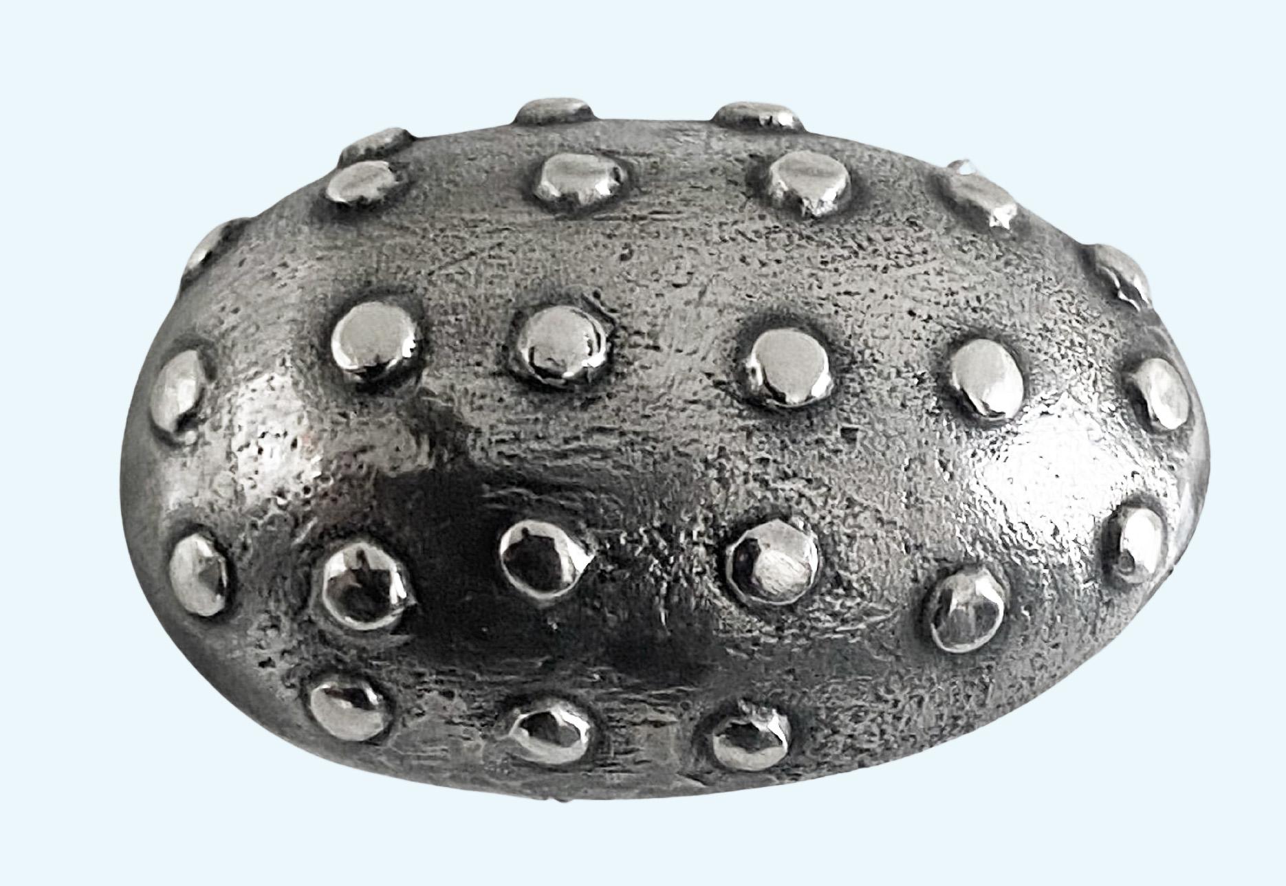 Mid century oxidised silver egg brooch, Sweden 1948. The brooch with contrasting matte finish background accented with polished rivet design. The oxidised silver with polished rivets offers a strong contrast. Swedish silver hallmarks for 1948,