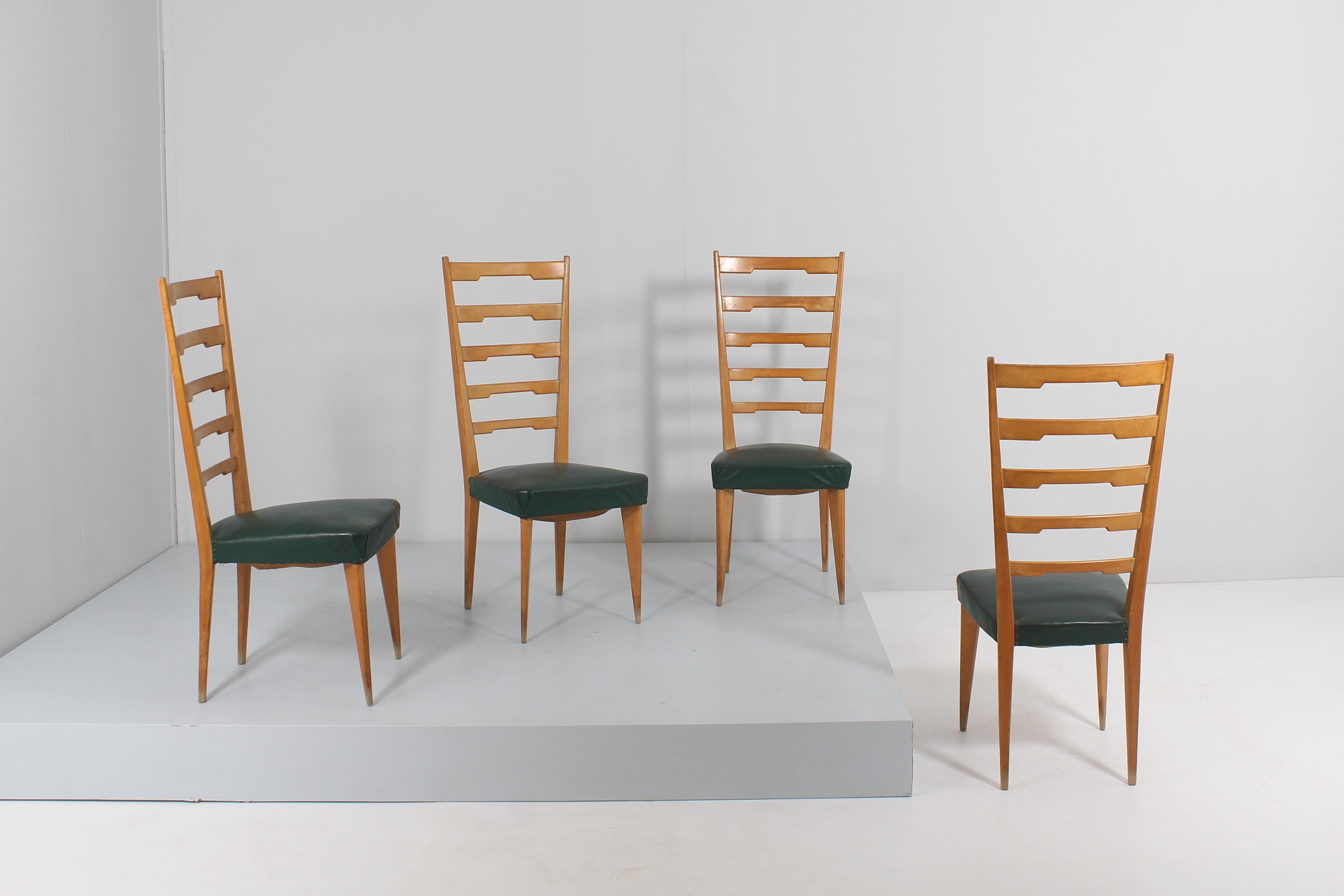 Beautiful and elegant set of 4 chairs, in light wood, high back with shaped horizontal elements and spiked legs. The seat is lined in dark green synthetic skai. Italian production from the 60s in the style of Paolo Buffa.
Wear consistent with age