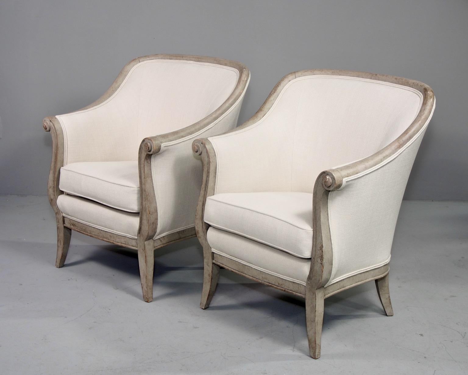 Pair of upholstered arm chairs with curvy wood frames and a greige painted finish, circa 1980s. Curved back rests and removable seat cushion. Newly upholstered in commercial-grade off-white linen/cotton/poly blend dobby weave fabric. Made by Decca