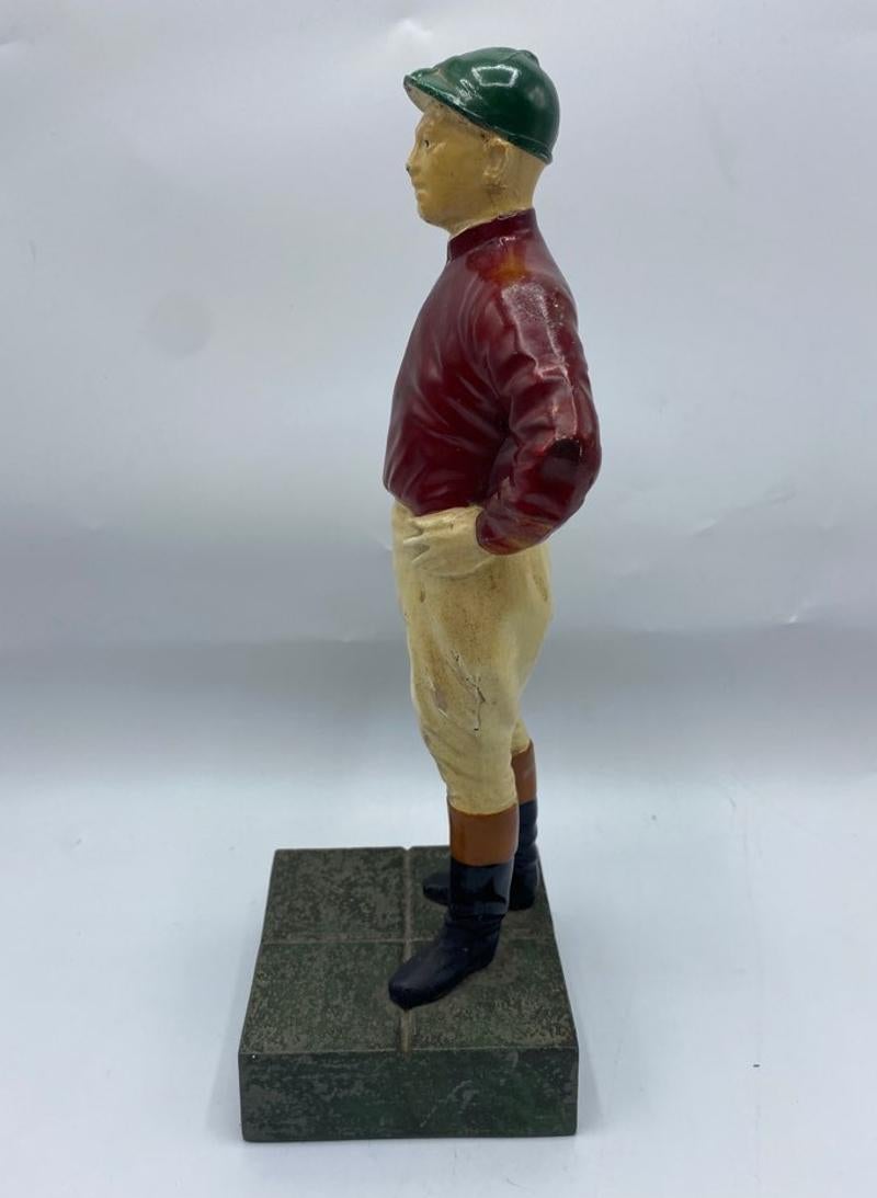 Midcentury painted metal jockey door stop. Still maintains bright colors of his wardrobe - green hat, red jacket and ivory color pants. Sturdy and ready to hold court at any door. Circa 1960s-1970s.
Measures: 10.5