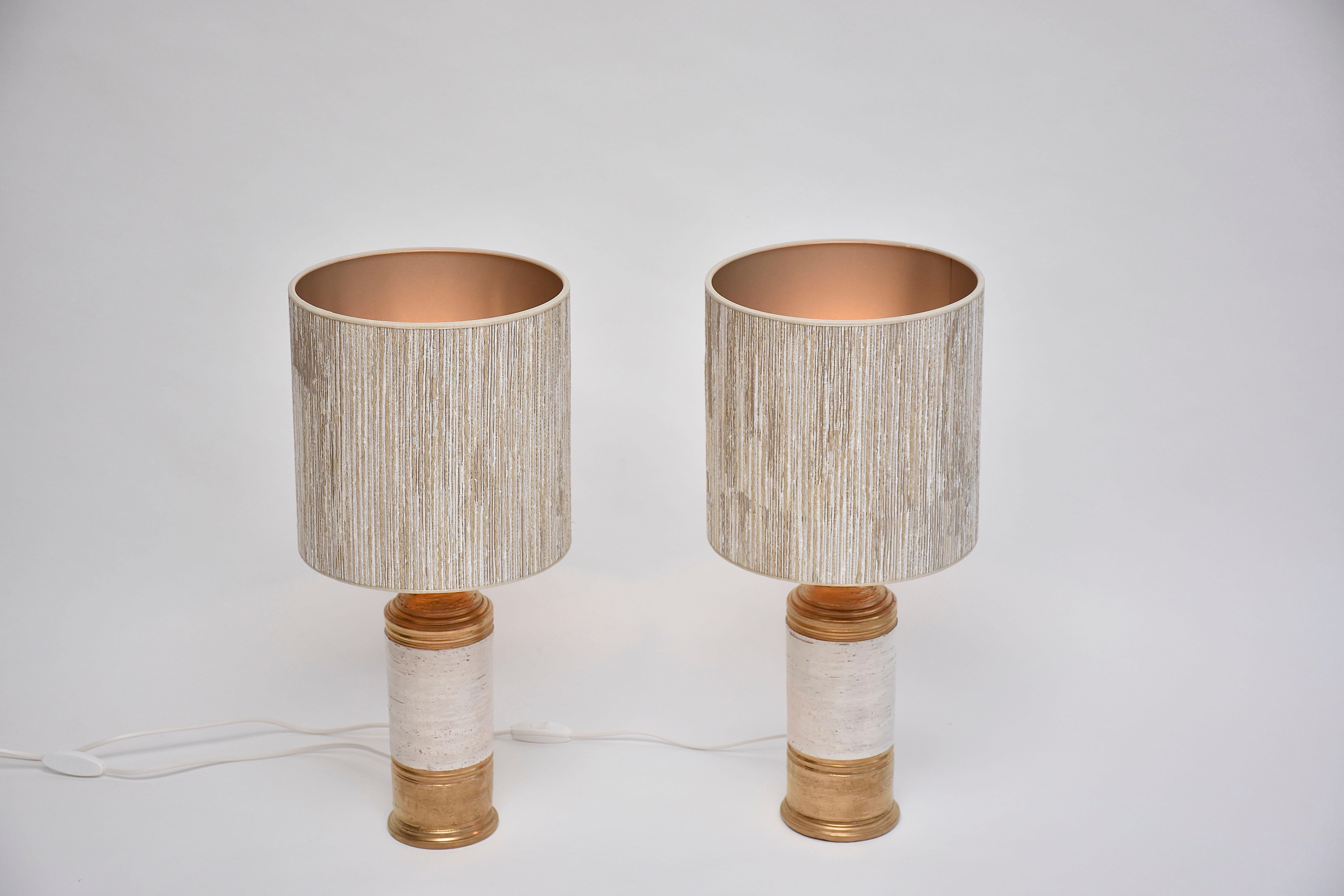 Beautiful pair ceramic table lamps designed by Bitossi for Bergboms- Sweden.
These pretty lamps have gold glazed base and top with in the centre off-white glazed 'birch' texture.
Period- ca. 1960
Place of origin- Italy/ Sweden
Labeled at the