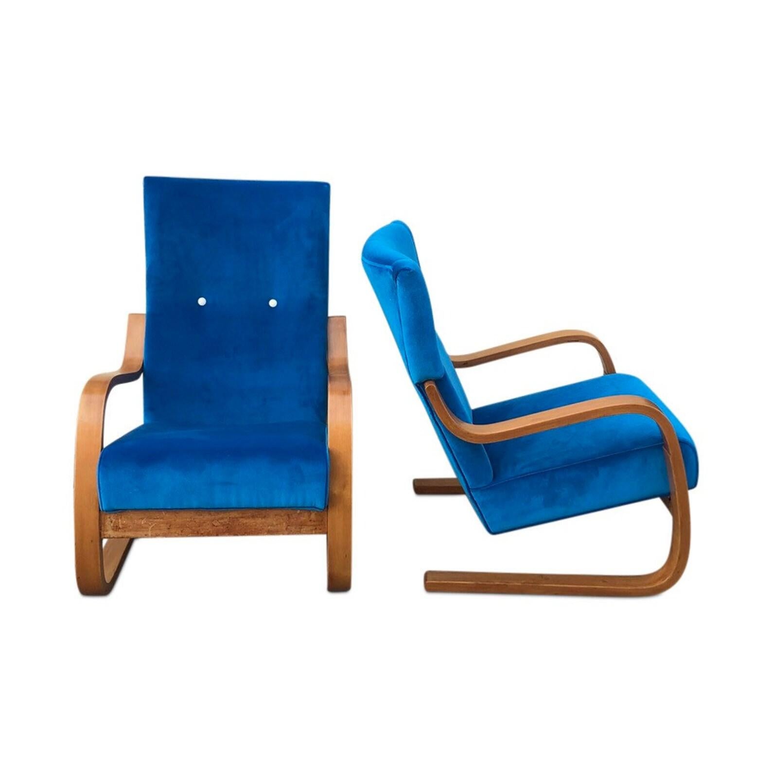 Curated Pair of original, vintage chairs by the acclaimed Finnish designer and architect Alvar Aalto. The cantileverd wood frame with new real holly hunt bright blue velvet seat and back. Armchairs, bergere chairs, chairs, chaise longues, club