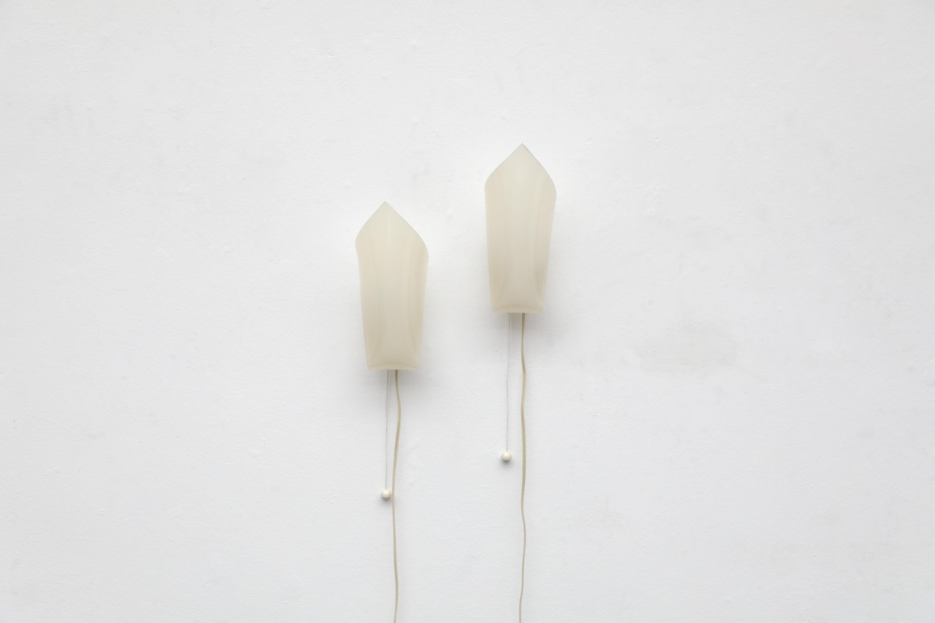 Beautifully shaped set of two Mid-Century Plexi wall sconces by German designer Hanns Hoffman-Lederer. Lederer created an entire line of Plexiglas sheet wall and table lamps, which were manufactured by HL-Leuchten. These are a characteristic example