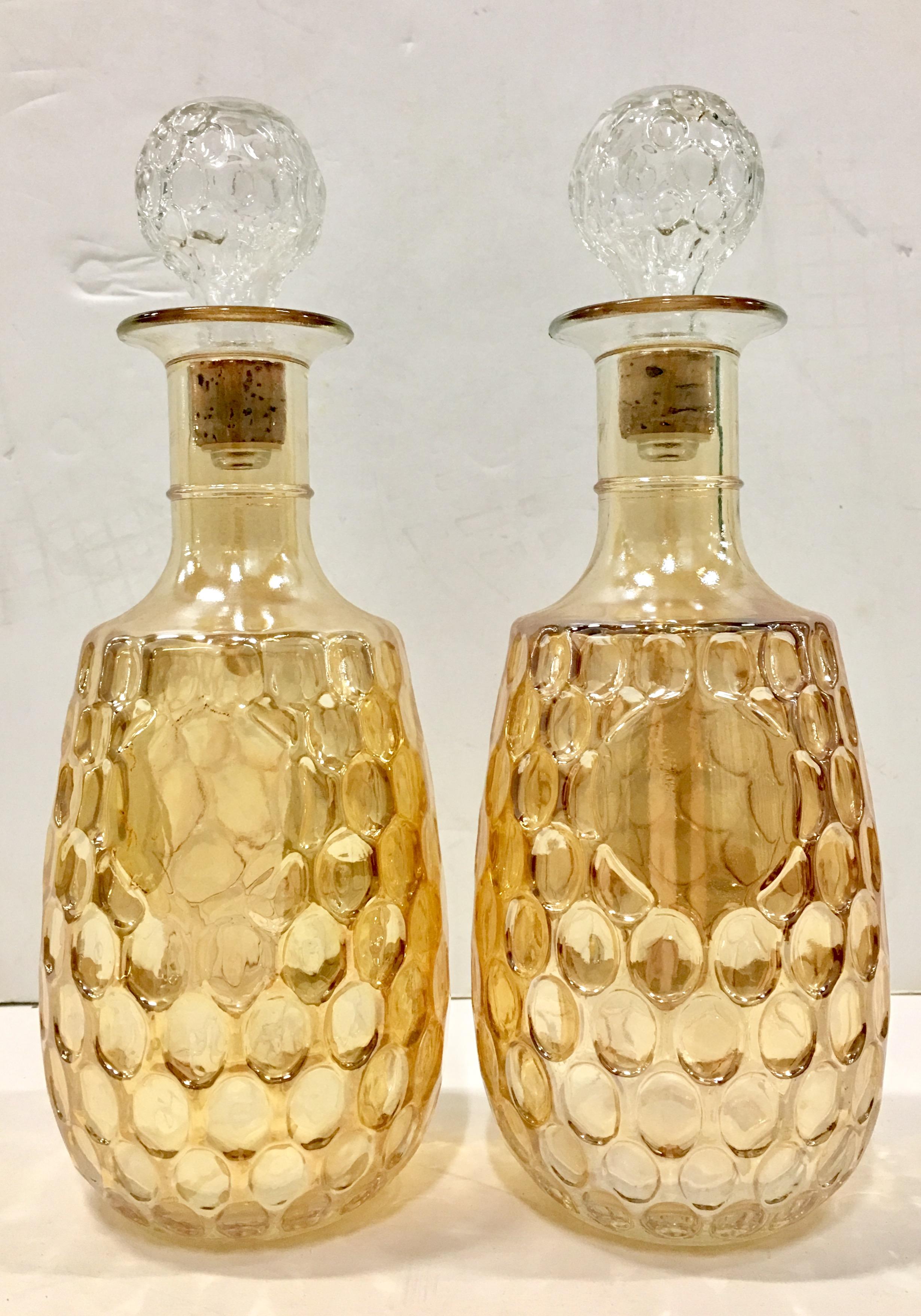 Mid-Century Rare Pair Of American blown glass iridescent marigold thumbprint pattern Liquor Decanters with stoppers. Features a clear and bulbous honeycomb stopper.