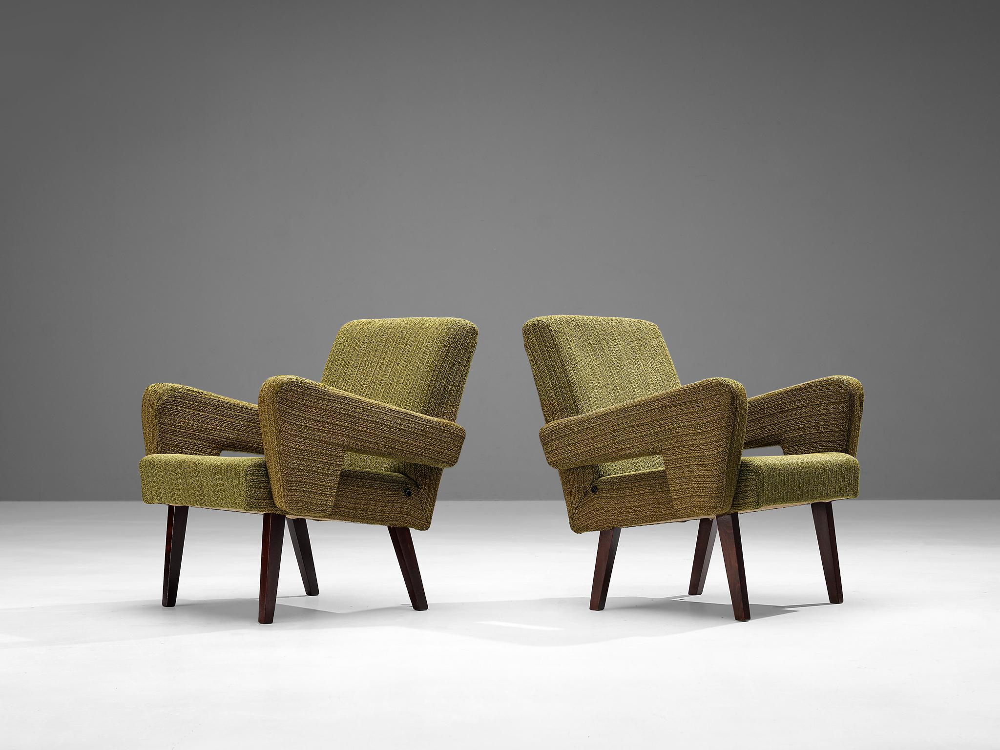 Pair of lounge chairs, fabric, stained beech, Czech Republic, 1960s

These well-proportioned armchairs are clear in their appearance with angular shapes and striking lines dominating the layout. A noticeable feature are the armrests that gradually