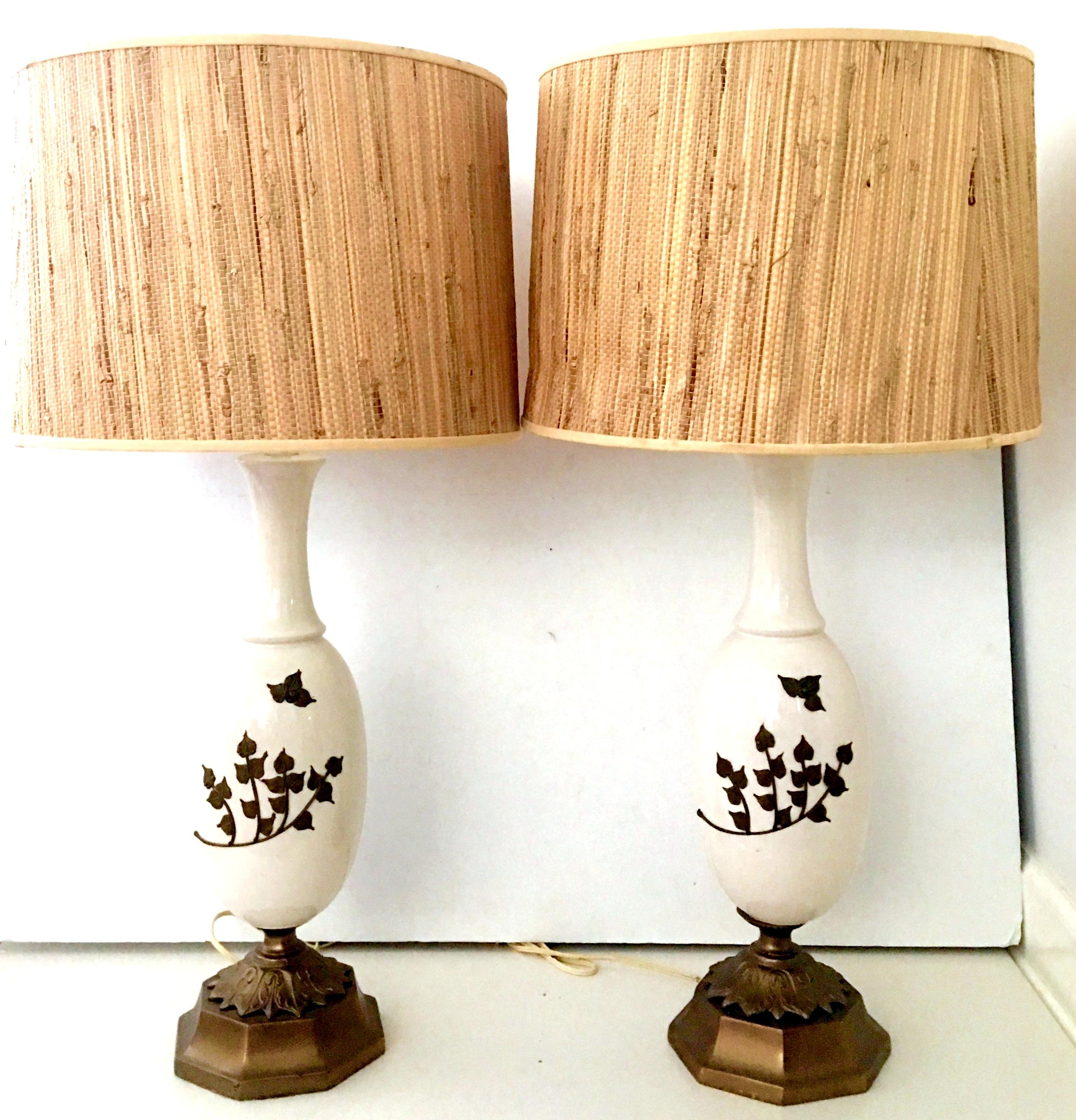 Mid-20th Century Art Nouveau Ceramic Glaze & Bronze Ostrich Egg Form Table Lamps. This incredibly and unique pair of lamps feature an off white ground with hand applied abstract formed bronze floral motif.  Mounted on double bronze base. Includes