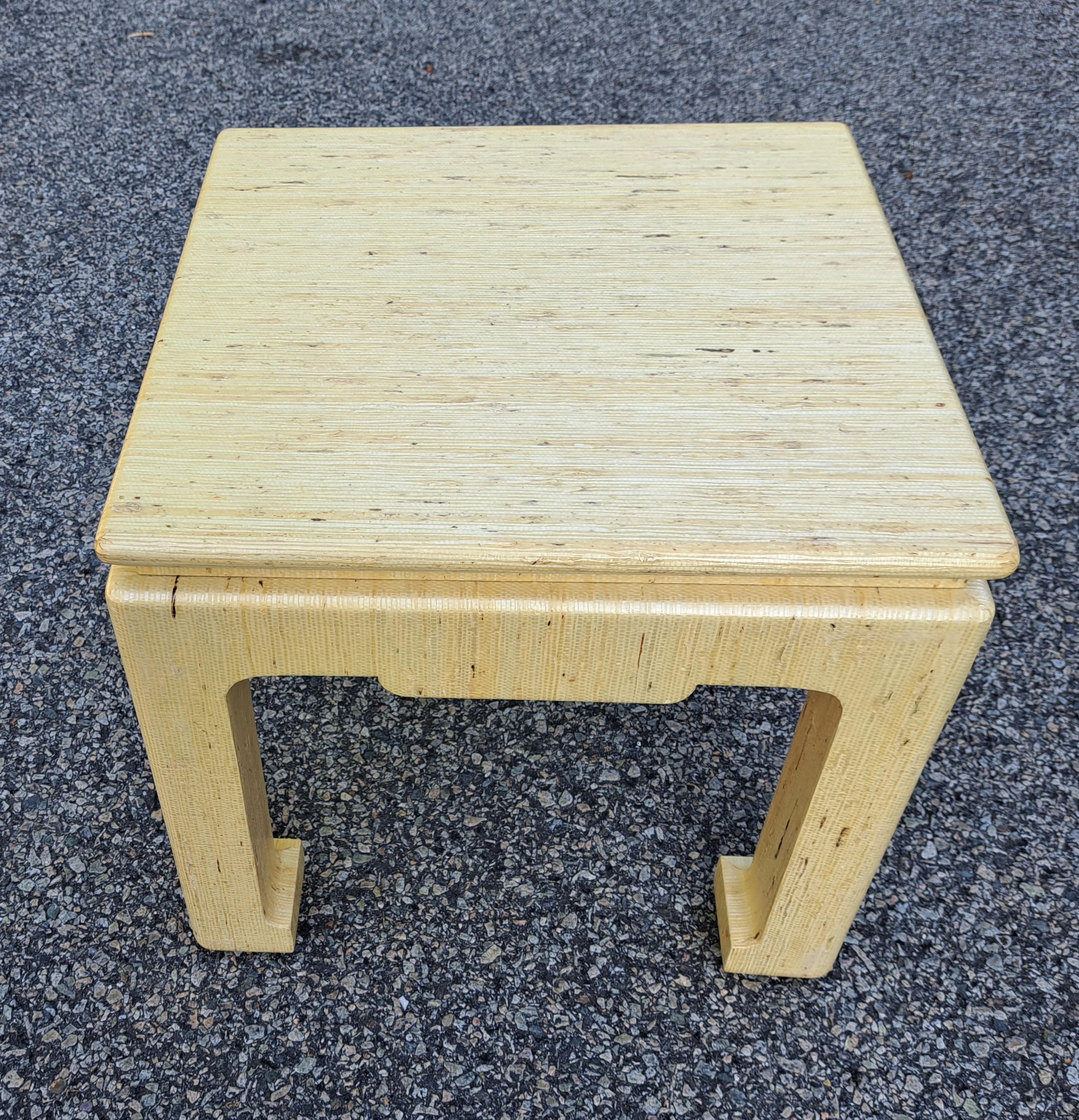 Pair of Baker Furniture Company small Asian side tables. Ligt yellow tables are covered in lacquered grass cloth. Size and portability make these tables perfect for small or large areas.