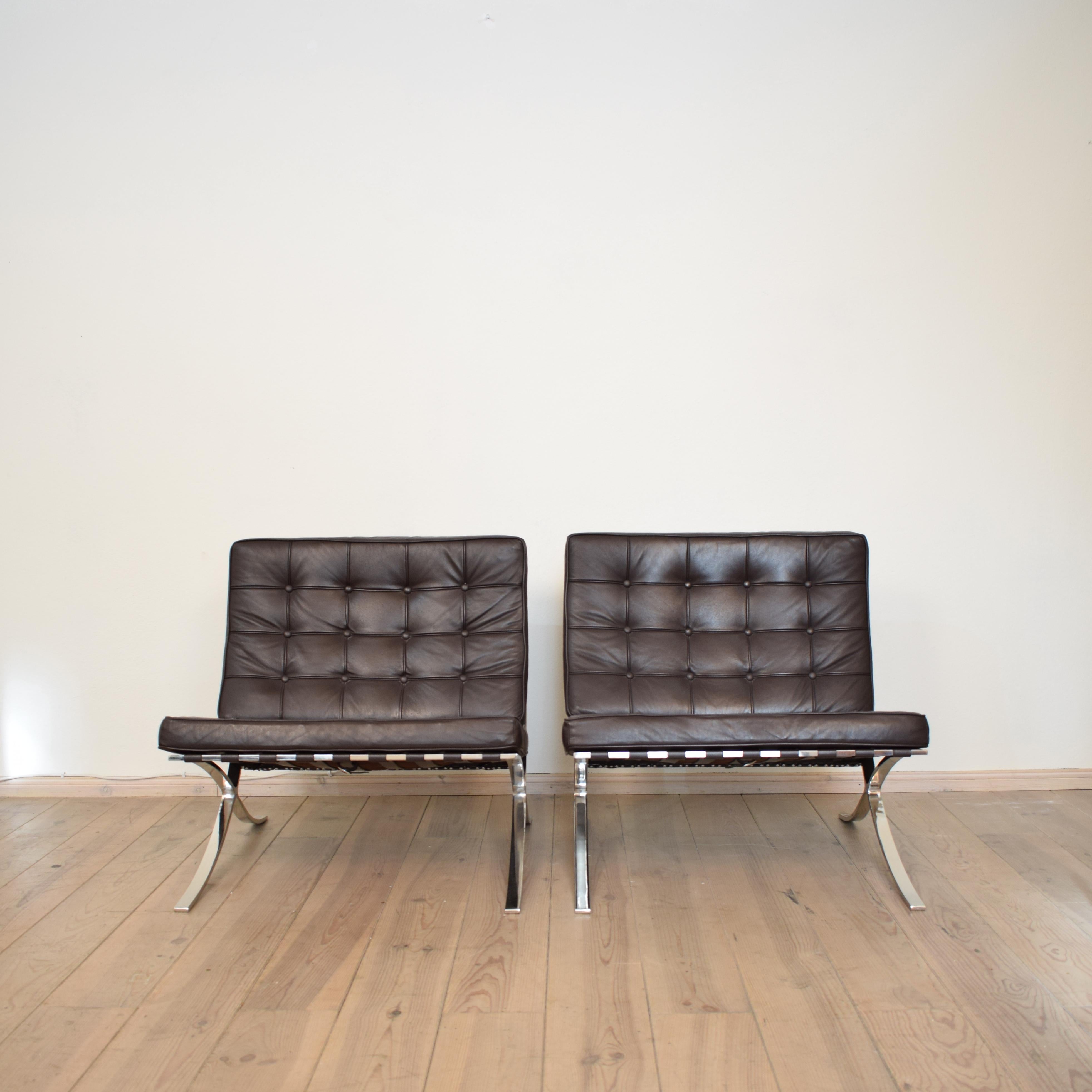 This Pair of Barcelona chairs where made in the early 1980s. The are in dark brown leather.
The chair which was designed Ludwig Mies van der Rohe in 1929. 
It is not the original it is in the style of, but they are very good quality and in perfect