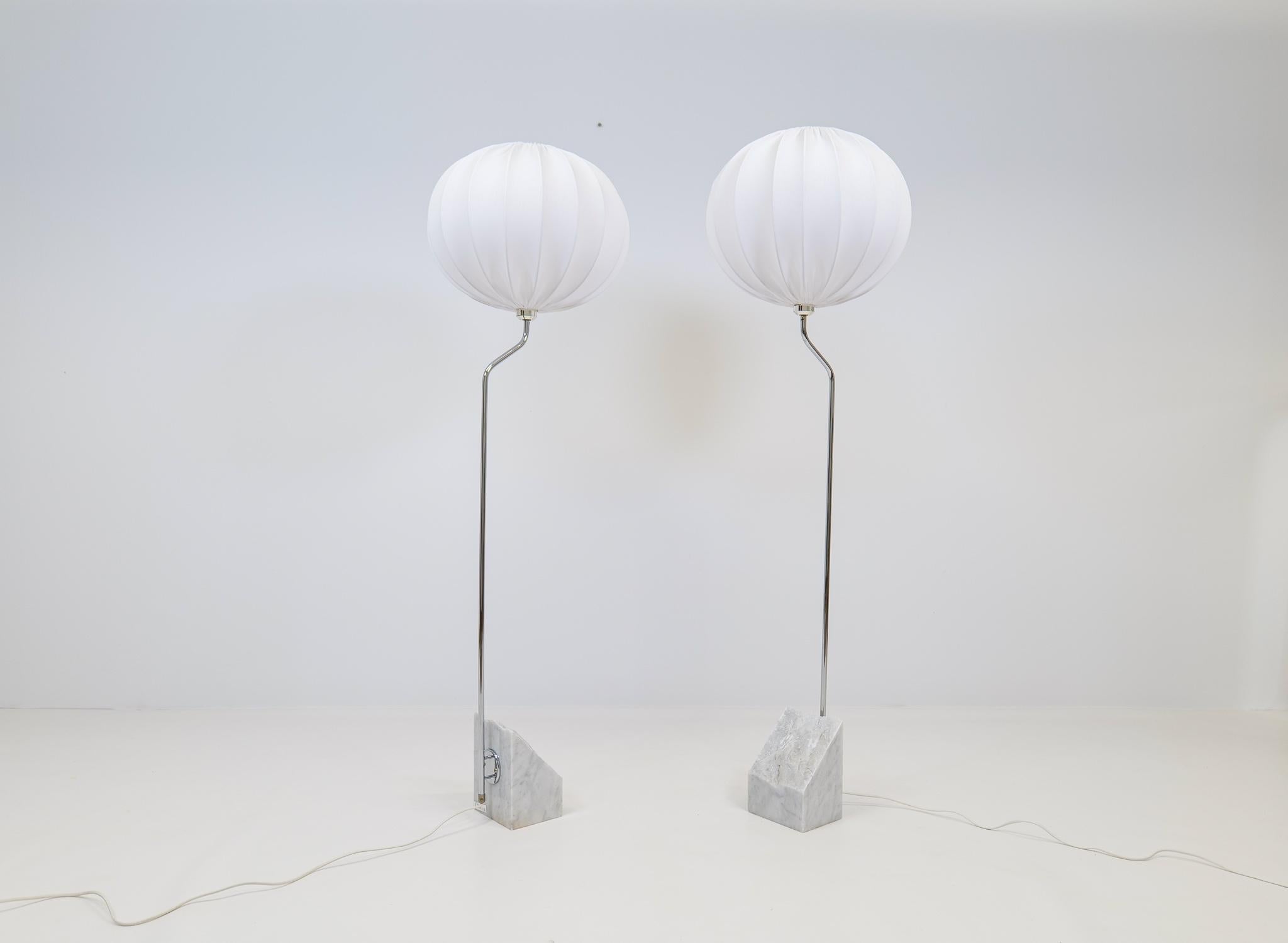 Large and heavy pair of marble stone floor lamps with chromed steel arms. Bergboms design with all new cotton shades, made in Sweden This pair of table lamps will give that great look to a vintage home or a twist to the modern home. This pair with