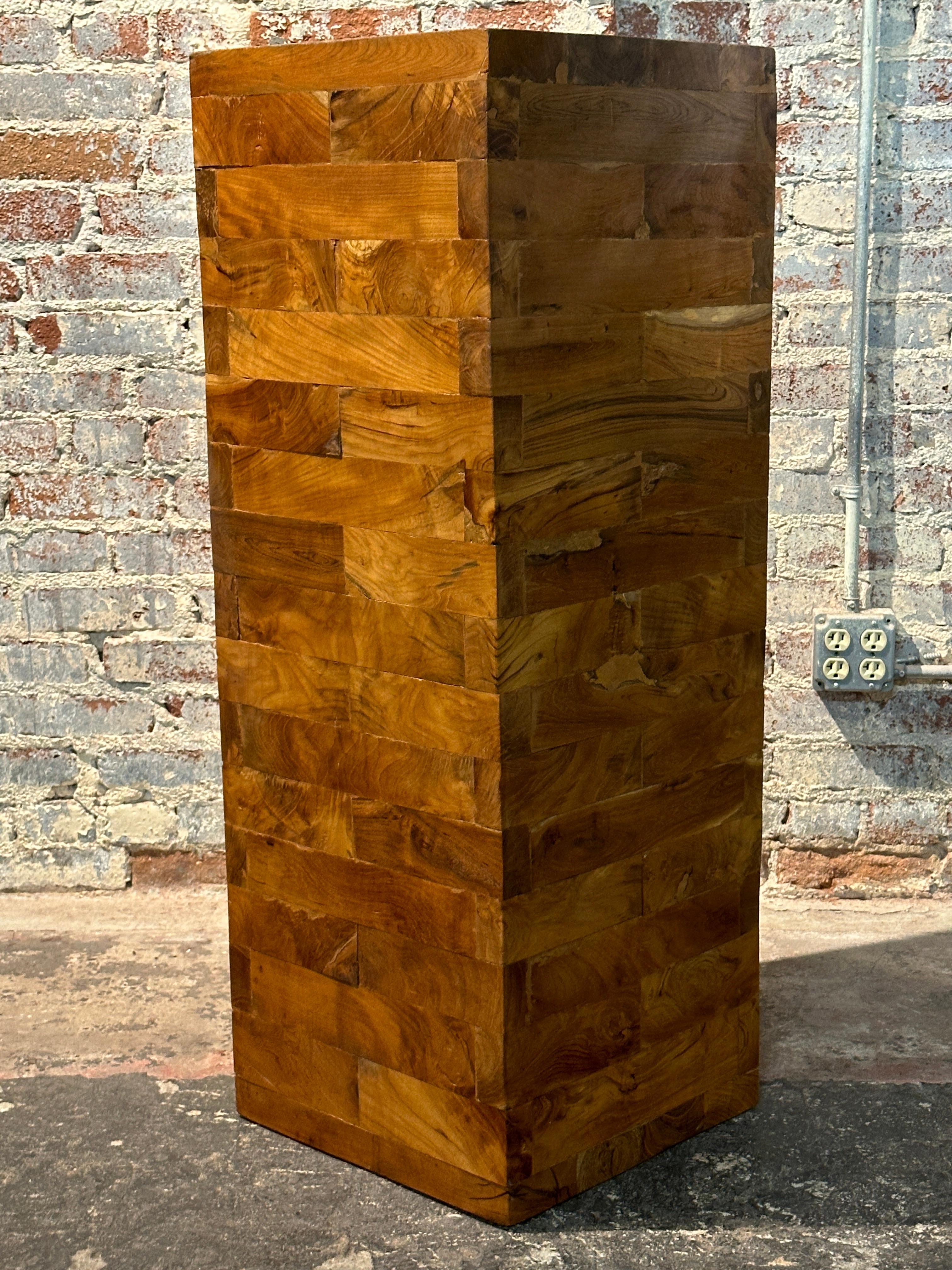 This Pair of Brutalist Walnut Pedestals/Benches inspired maybe by Milo  Baughman  showcase the timeless beauty of natural species of different woods. 

The rectangular solid wood blocks are meticulously assembled to form each pedestal. Thanks to the