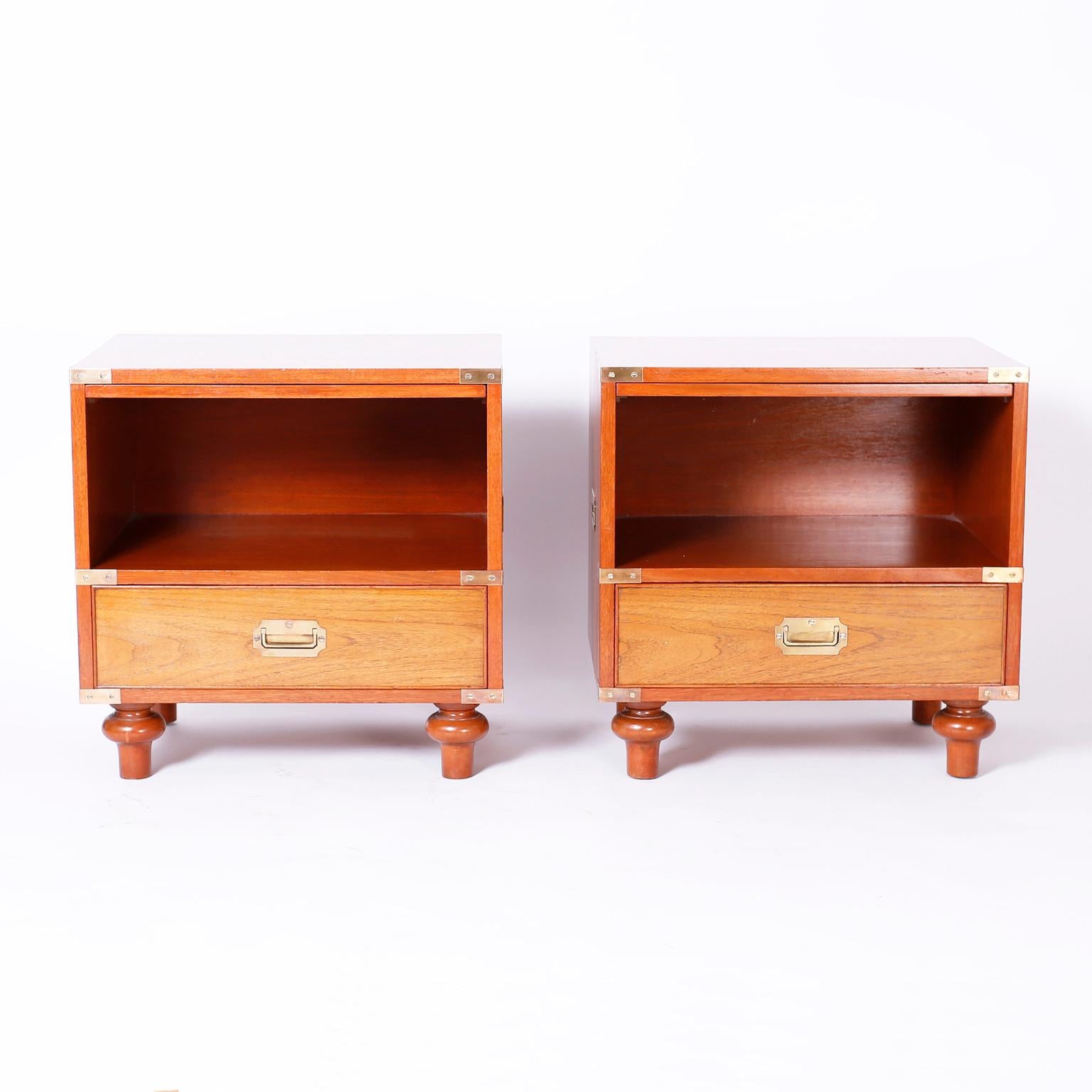 Handsome pair of bedside tables or nightstands with mahogany cases and walnut drawer fronts, brass hardware, slide out utility trays and turned feet. Signed Beacon Hill in a drawer.