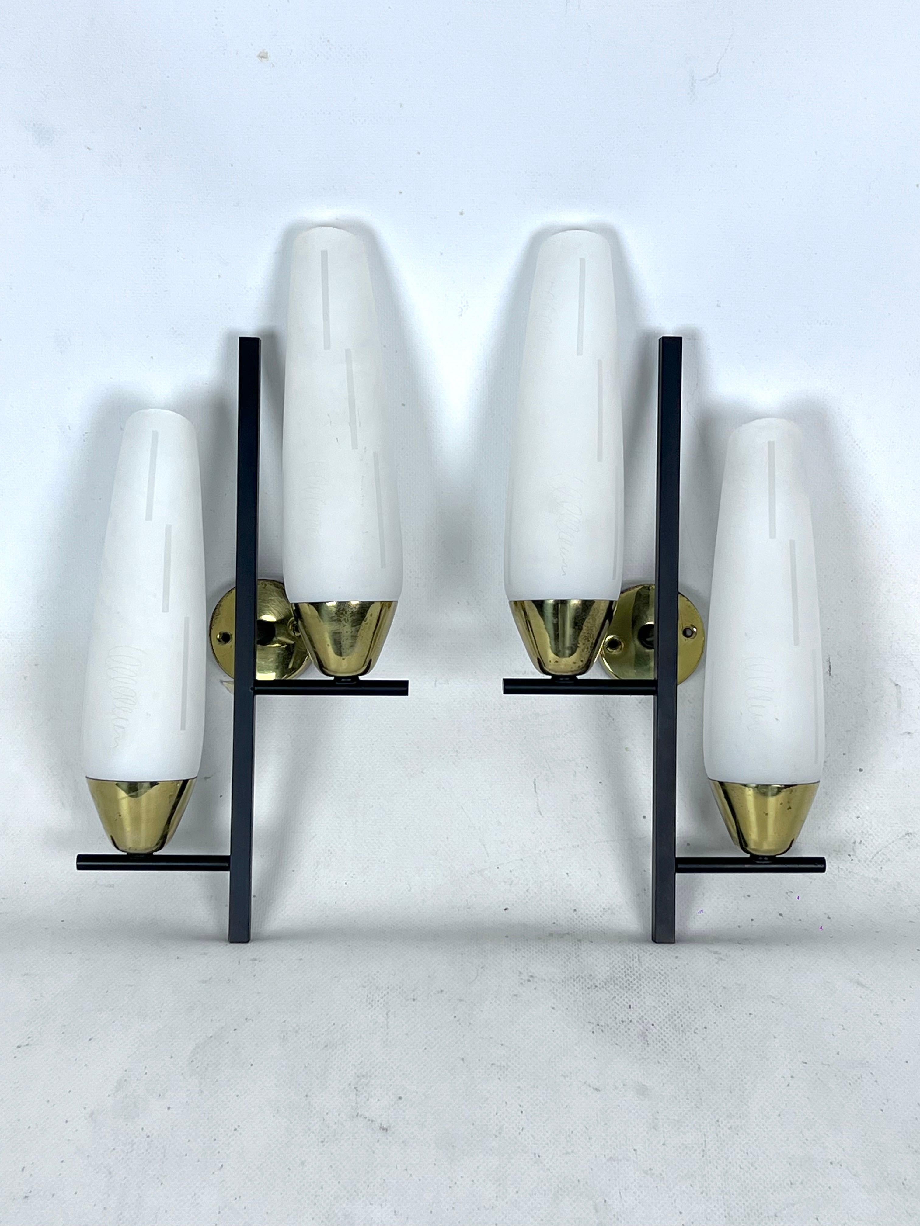 Good vintage condition with normal trace of age and use for this set of two sconces made from brass, lacquered metal and opaline glass. No cracks or chips. Produced in Italy during the 50s and reminiscent of Stilnovo style. Full working with EU