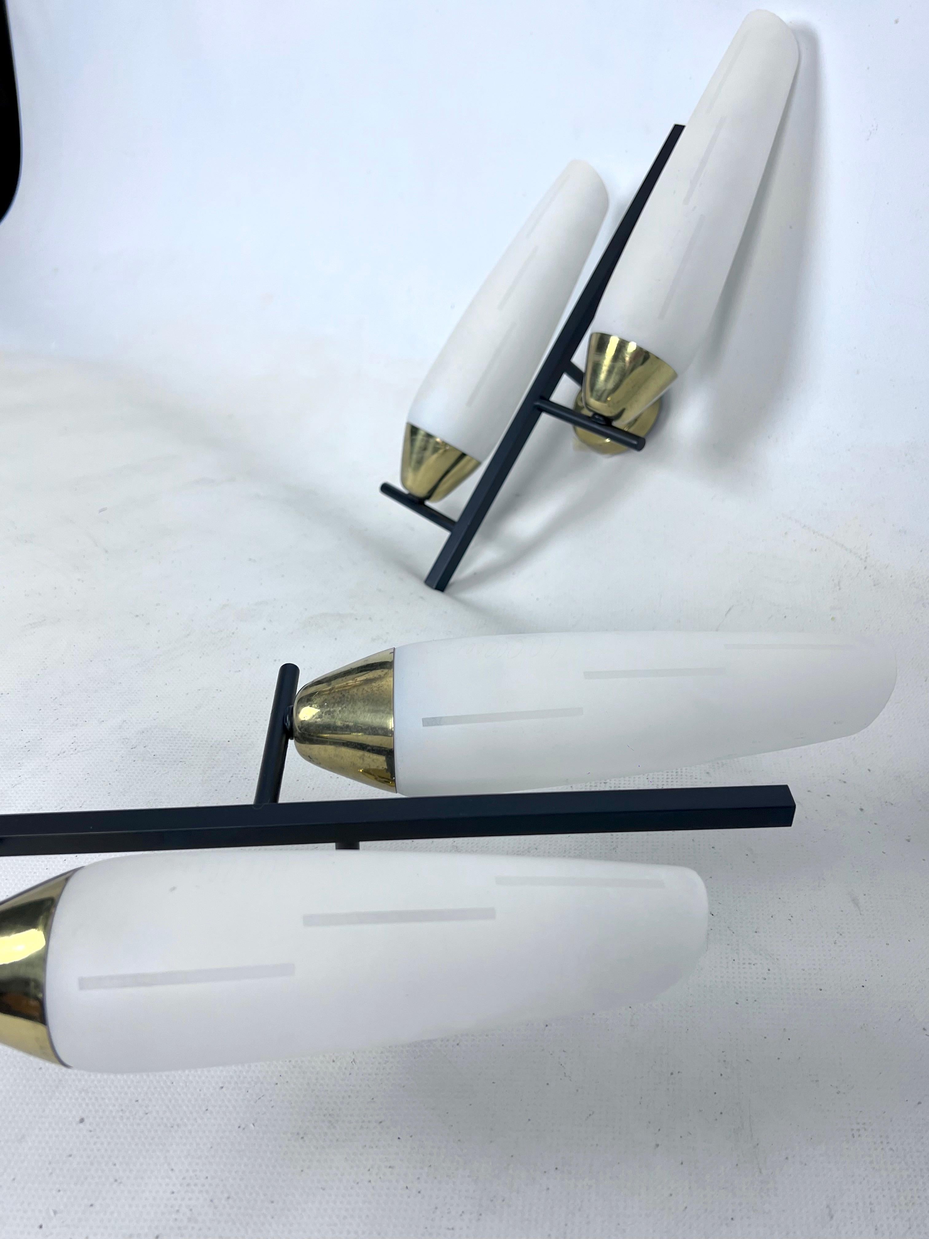 Brass Mid-Century pair of double lights sconces in brass and opaline glass. Italy 1950 For Sale