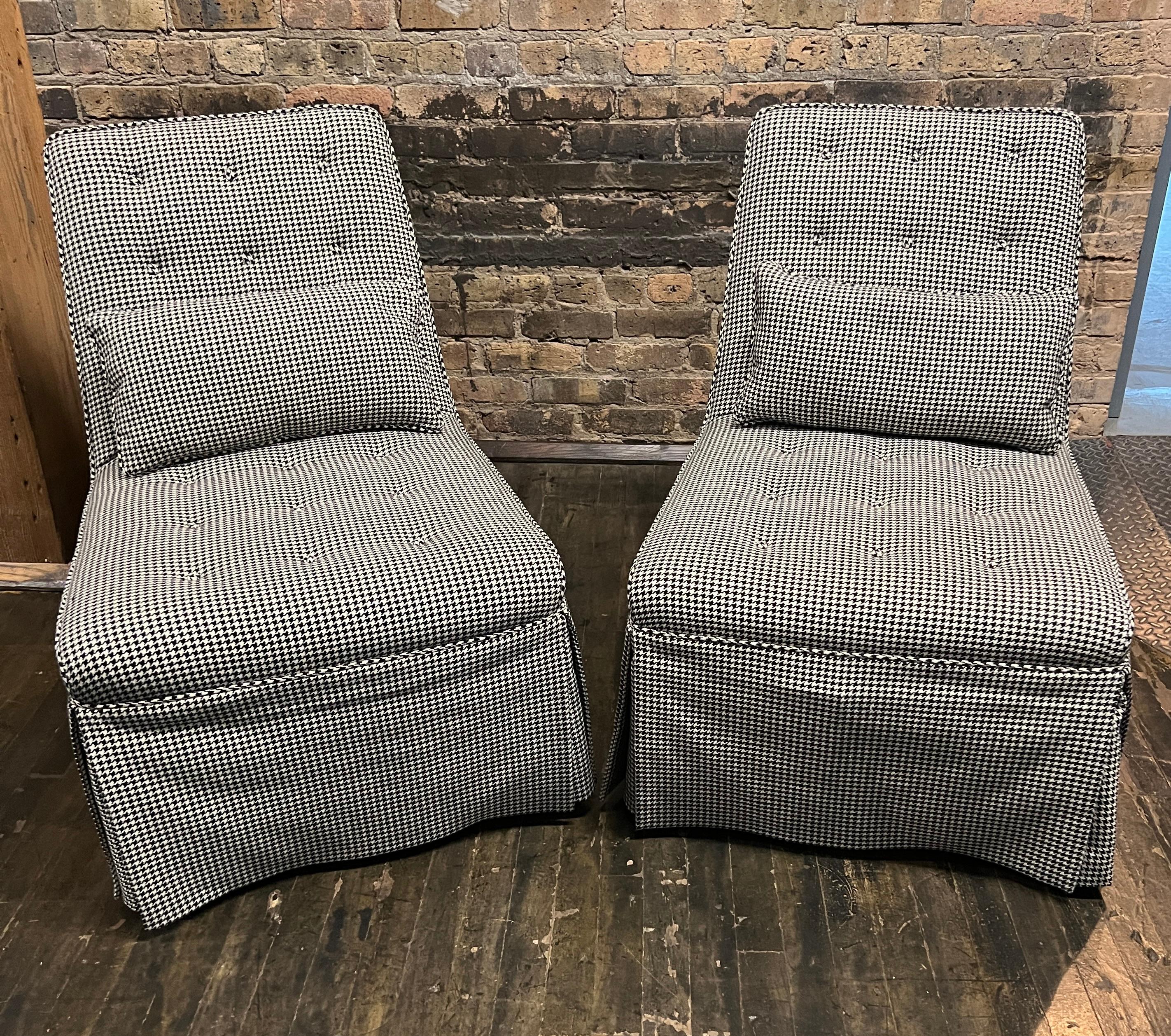 Beautiful and elegant pair of armless slipper chairs designed by Edward Wormley for Dunbar. This set appears to have been reupholstered (beautifully and professionally) at some point (and a skirt was added). The fabric is a black and cream