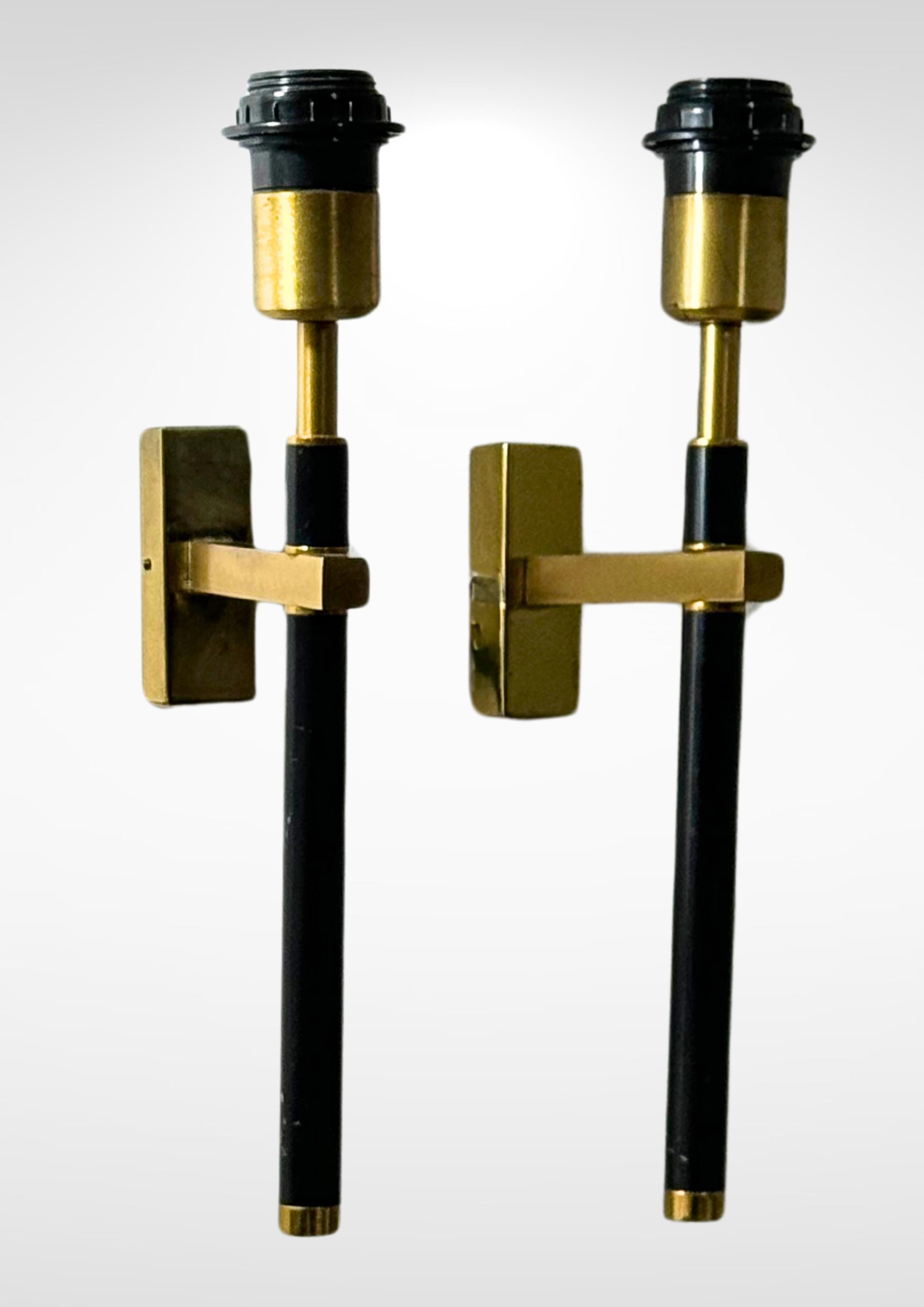 Mid-century pair of wall sconces in the manner of Maison Charles-Jansen circa 1970s.
Made of tubular brass rods with lacquered mid-sections.
Uses E27 light bulbs.

Recently rewired to modern safety standards.