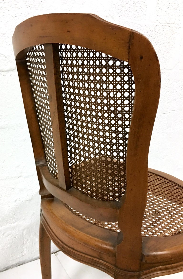 Midcentury Pair Of French Style Carved Wood and Cane Chairs For Sale at