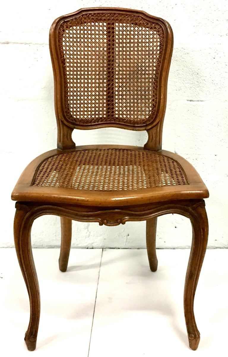 Midcentury Pair Of French Style Carved Wood and Cane Chairs For Sale at