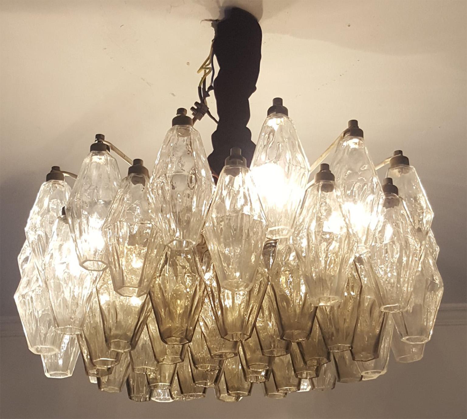 Two original Venini chandeliers manufactured in Murano glass; 
Model Poliedri in two colors with the core part in grey colored Poliedri,
 produced in Venice and designed by Carlo Scarpa. 
 The glass body has 51 cm of diameter and 30 height. Plus