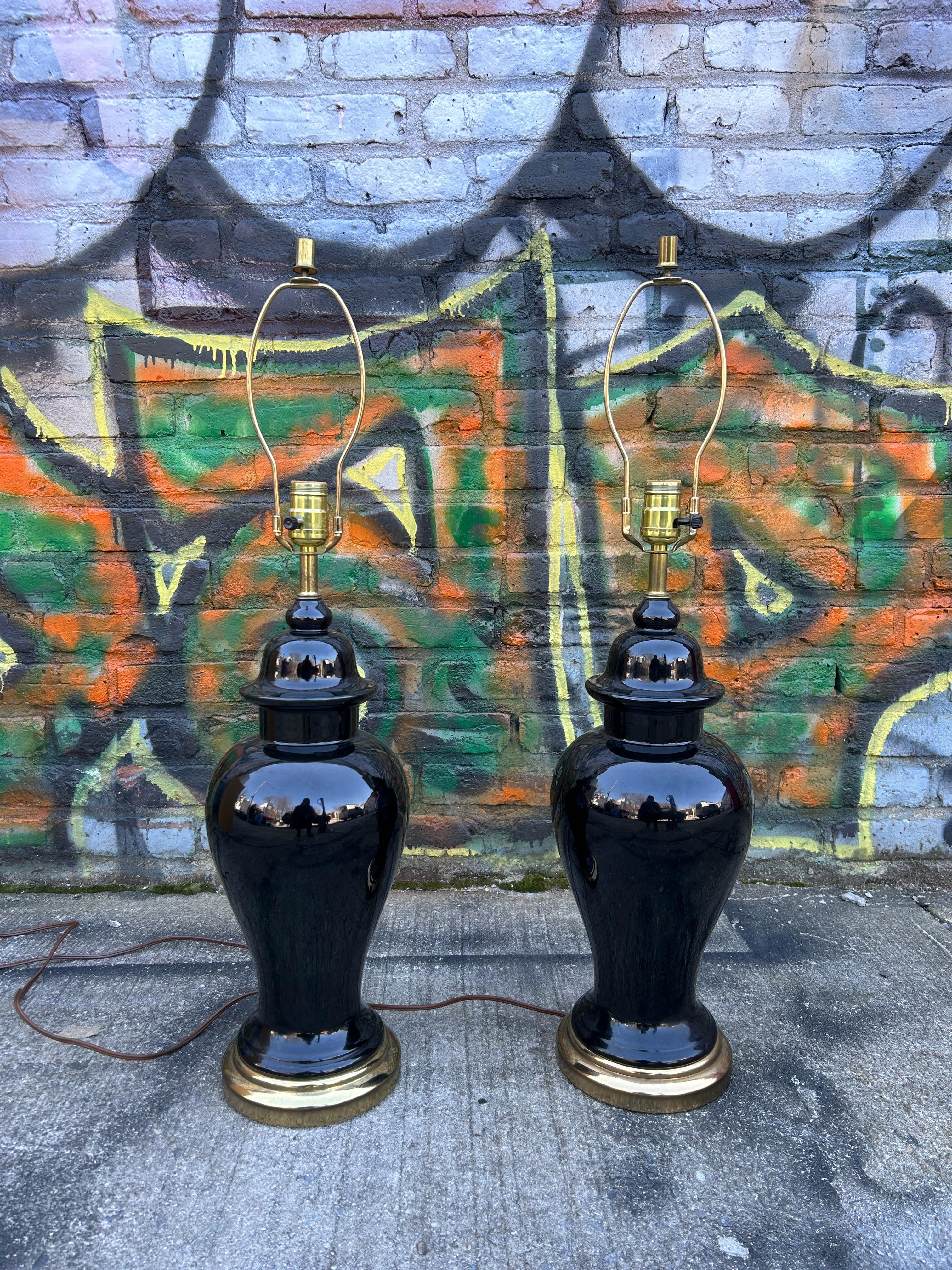 Mid-Century Modern pair of Hollywood Regency ceramic black and gold table lamps with shades. 120v American Plug - Lamps function 100% takes normal Edison Light bulbs. Located in Brooklyn NYC.