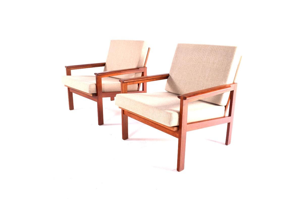 Beautiful pair of 1960s teak easy chairs. Model Capella by Illum Wikkelso for Niels Eilersen, Denmark. Solid teak wood base also in a very good condition with elegant slender designed frame and cushions upholstered. This chair offers excellent