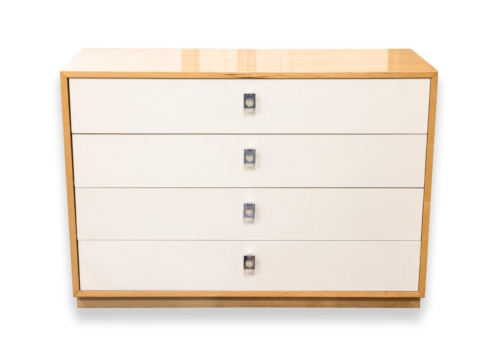 A pair of Jack Cartwright birch wood dressers for Founders Furniture. A cute set of dressers featuring a full birch wood construction, a semi gloss finish, and four equally sized pull out white dresser drawers. The Founders Furniture tag can be