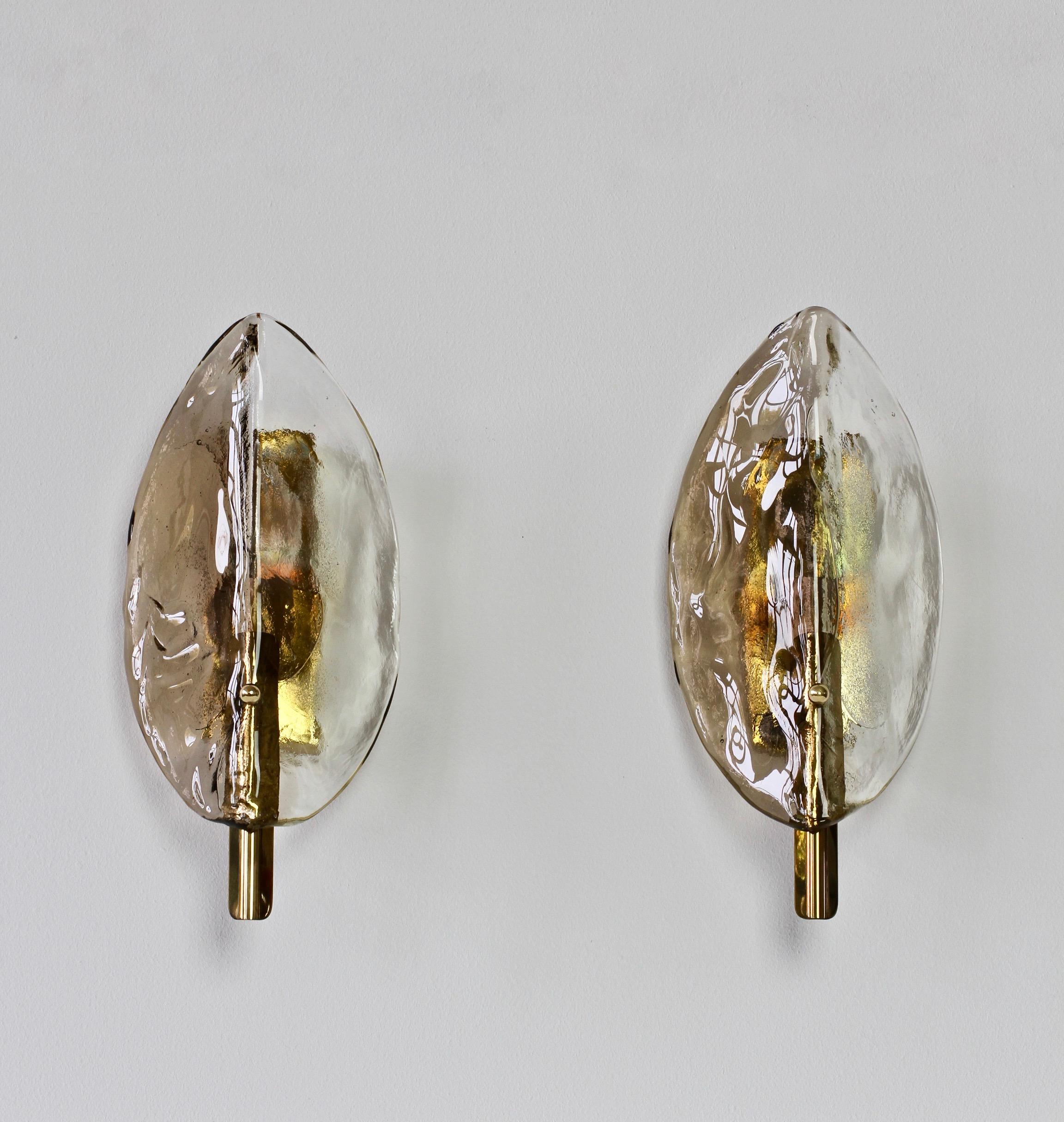 Vintage midcentury pair of brass, smoked and clear Murano glass wall lamps, lights or sconces by Austrian lighting manufacturer Kalmar, circa late 1970s. Featuring two folded, curved 'flower petal' shaped glass elements / shades, made by Italian