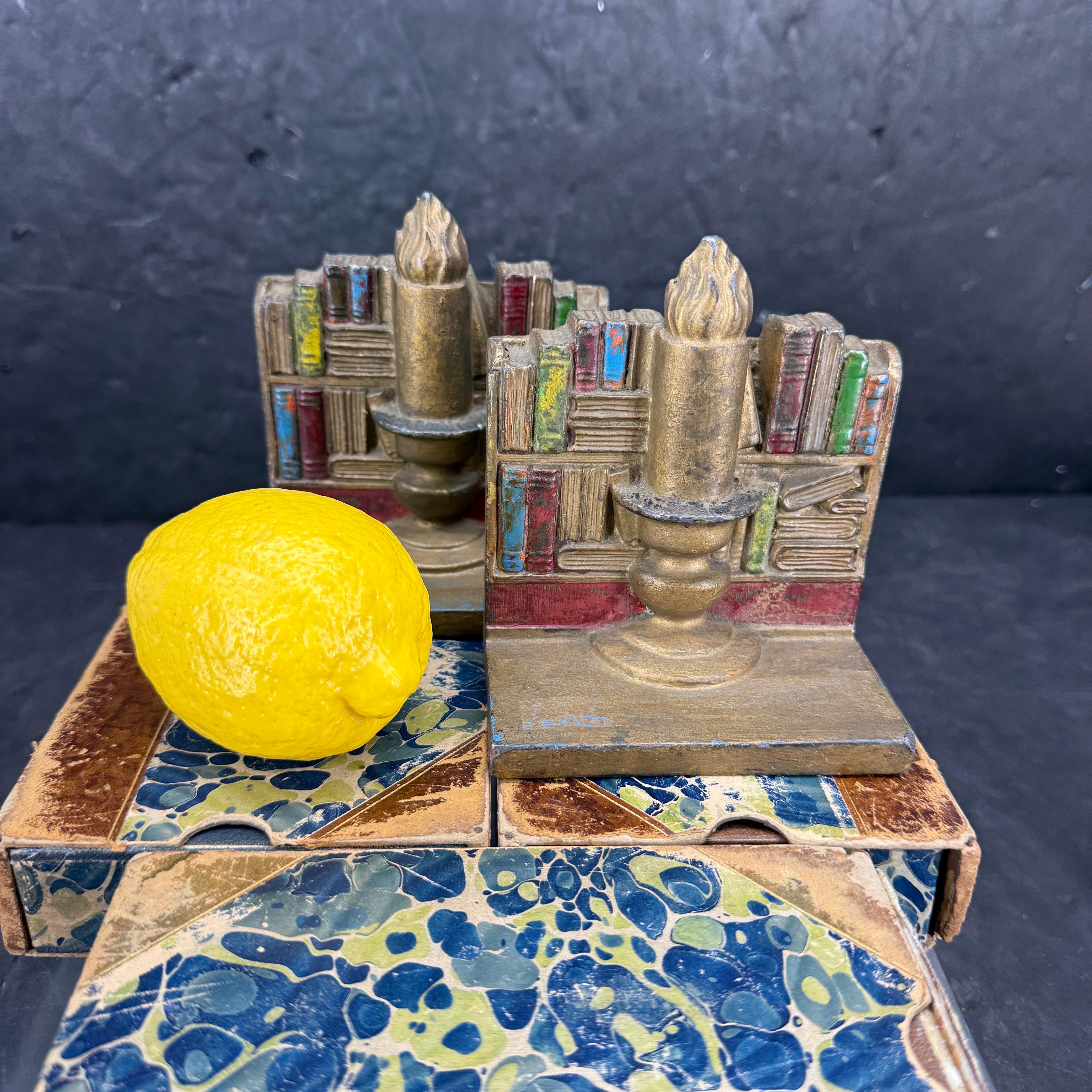 Very charming set of bookends featuring books and a candle, circa 1960's. We see these sturdy sculptures displayed in any family room or home office seeking a classic vibe. Great gift for the book lover in your life. 

