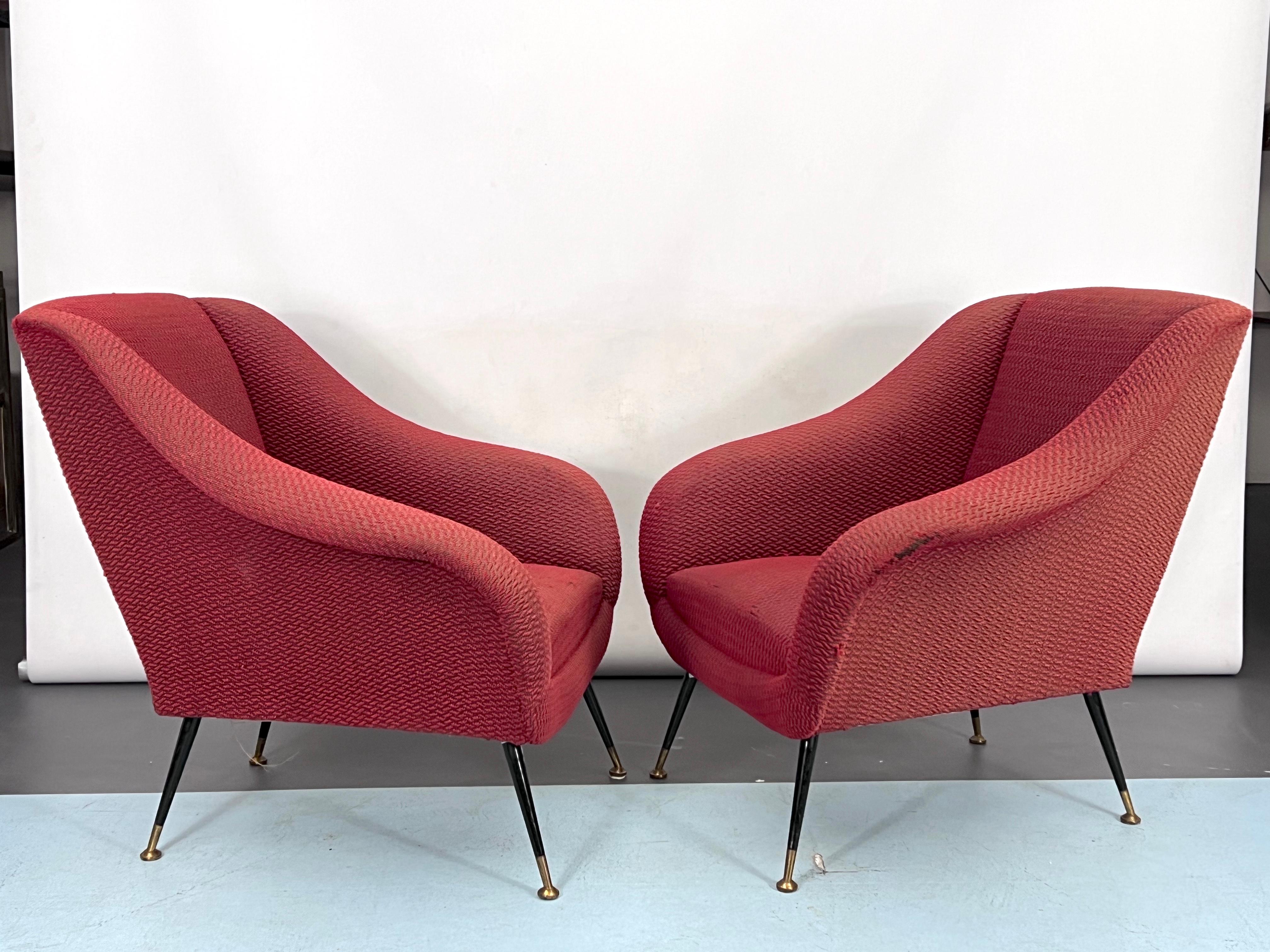 Set of two armchairs with brass feet and original fabric with evident trace of age and use and some rips. Designed by Gigi Radice and manufactured in Italy during the 50s.