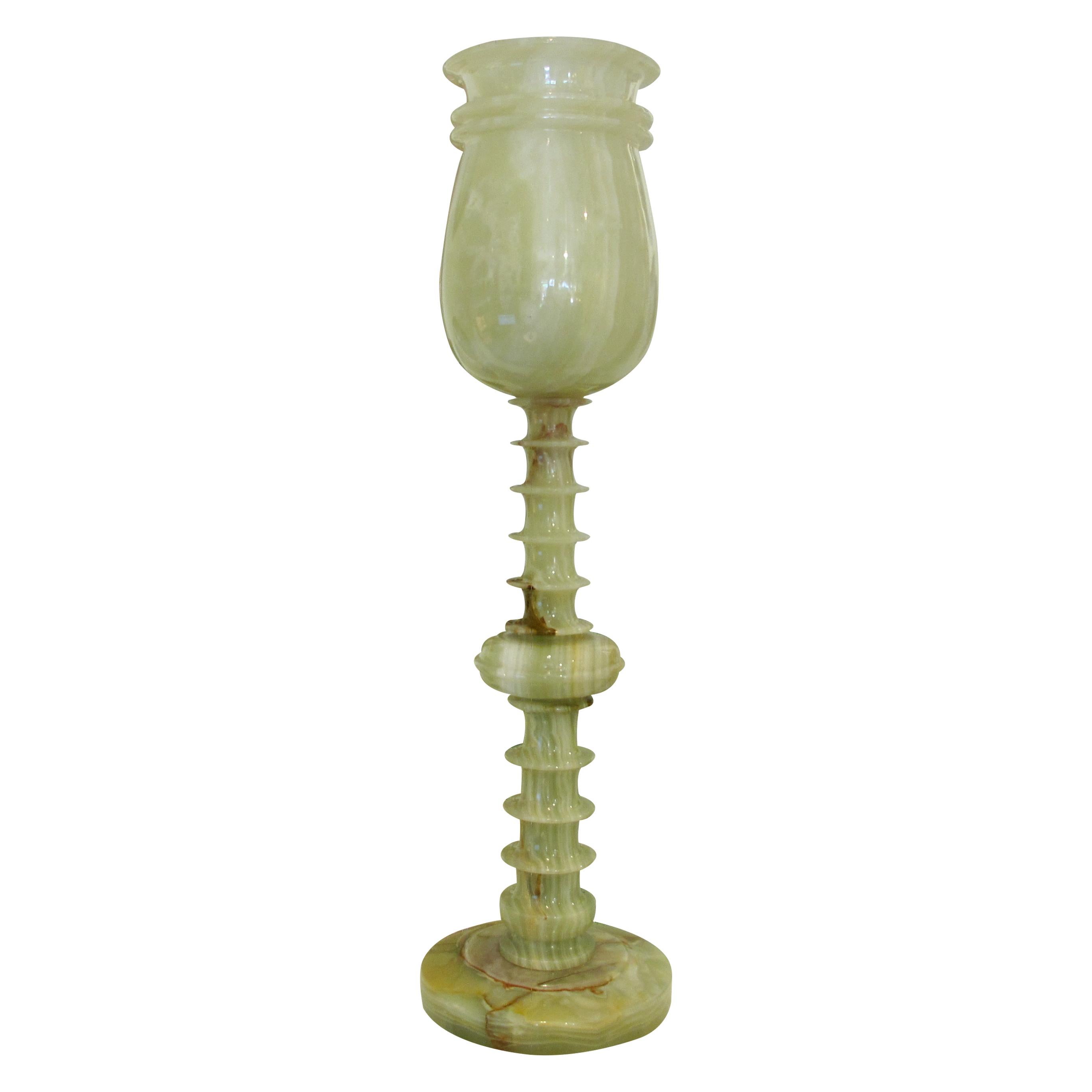 Pair of large elegant onyx table lamps from mid-century French showcasing a blend of natural beauty and sculptural design. Crafted from smooth, variegated green onyx, the lamps stand on a rounded base. The flared, chalice-shaped top harmonises with