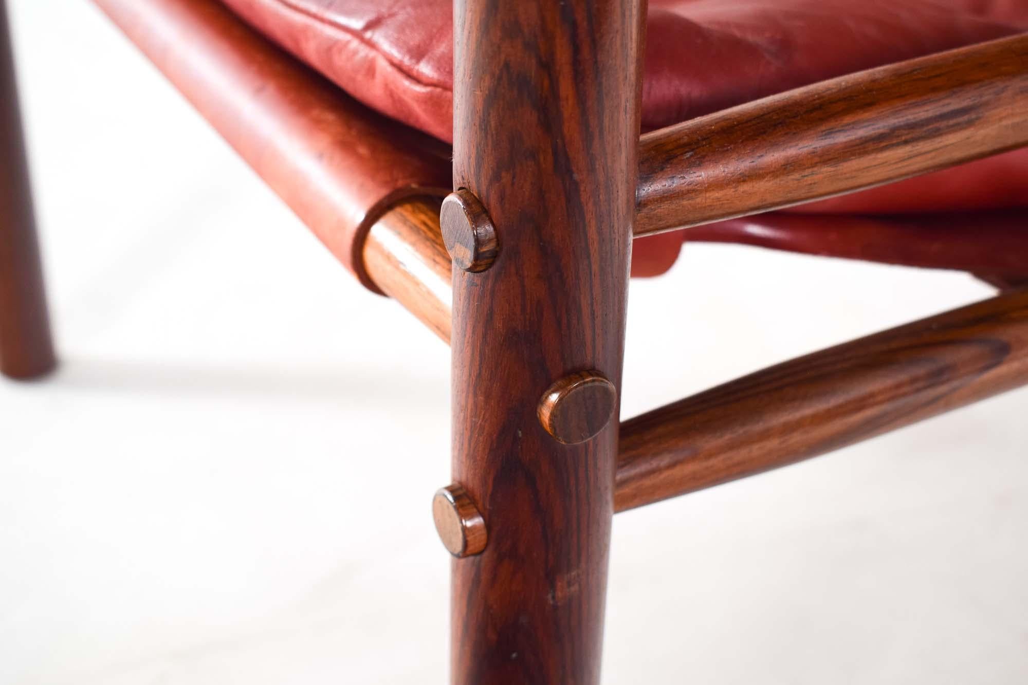 This pair of mid-century armchairs is an embodiment of Scandinavian design excellence, crafted by the esteemed Arne Norell, with a provenance rooted in 1960s Sweden. They showcase the clean lines, functional form, and use of natural materials that
