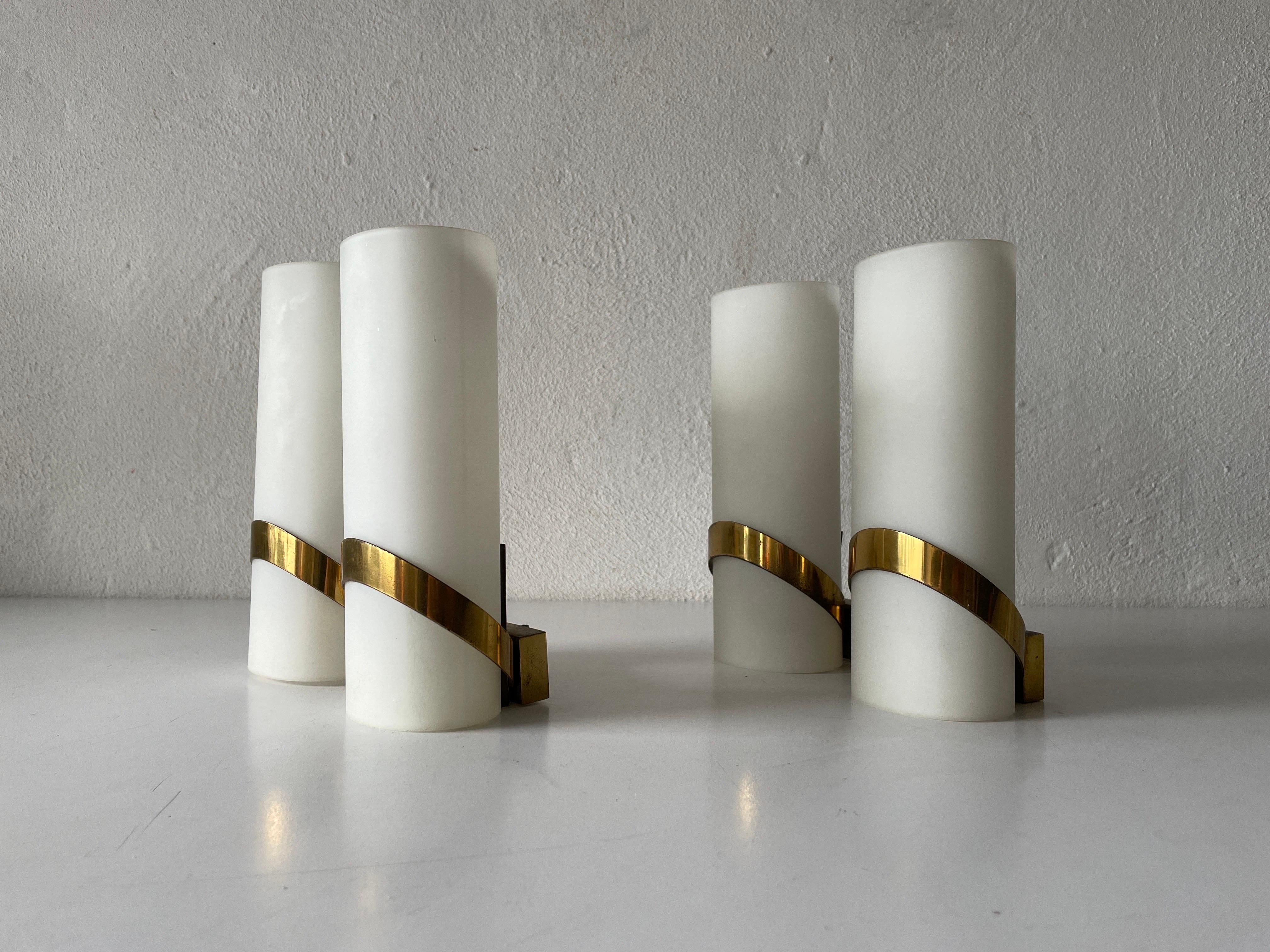 Mid-century pair of sconces by Stilnovo, 1950s, Italy

Very elegant and Minimalist wall lamps

Brushed satin glass diffusers and brass.

Lamp is in very good condition.
These lamps works with E14 standard light bulbs. 
Wired and suitable to