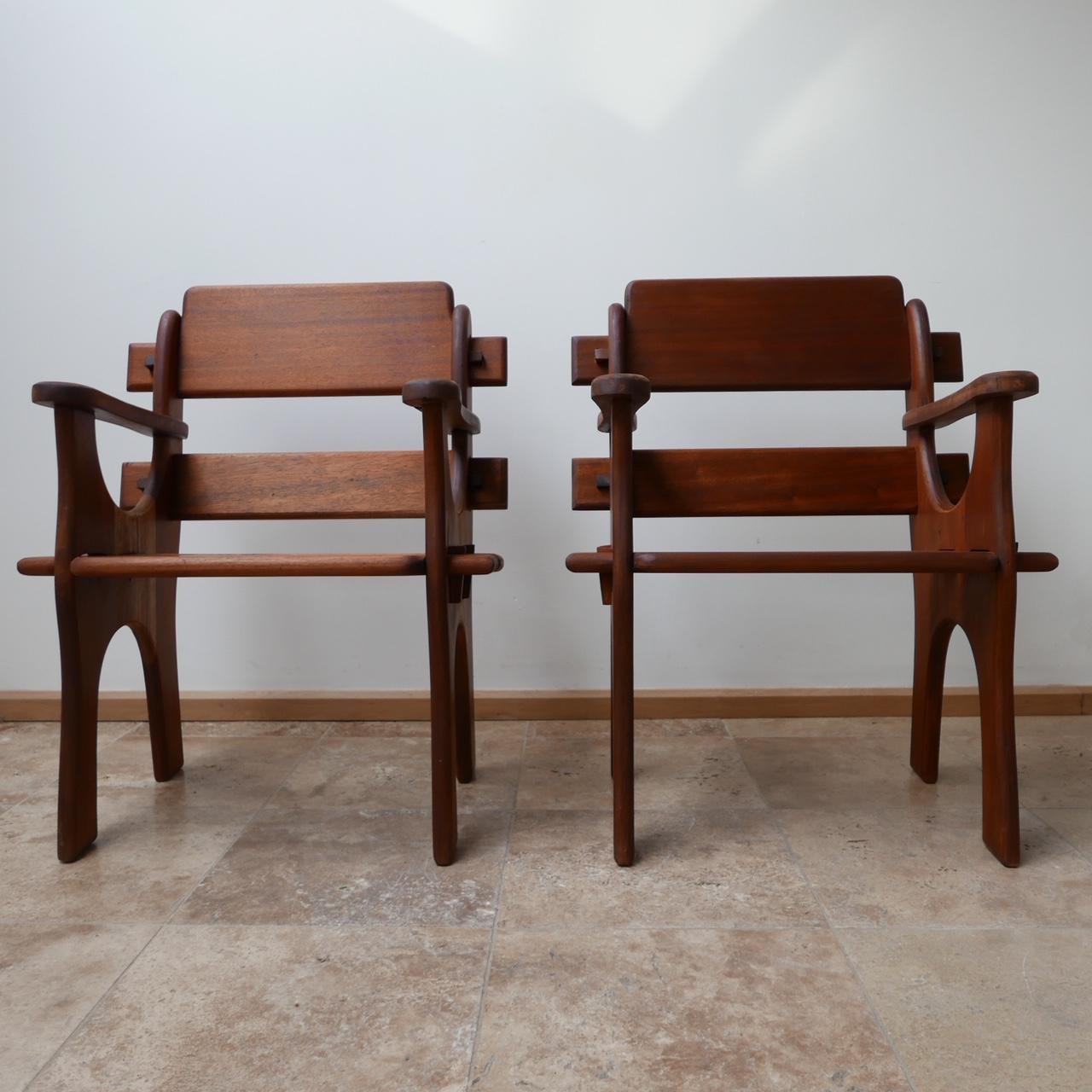 A pair of Brutalist armchairs.

Belgium, circa 1960s.

Believed to be rare Sipo/Utile wood. Unbelievable craftsmanship.

Dimensions: 67 W x 49 D x 43 seat height x 86 total height in cm.
 