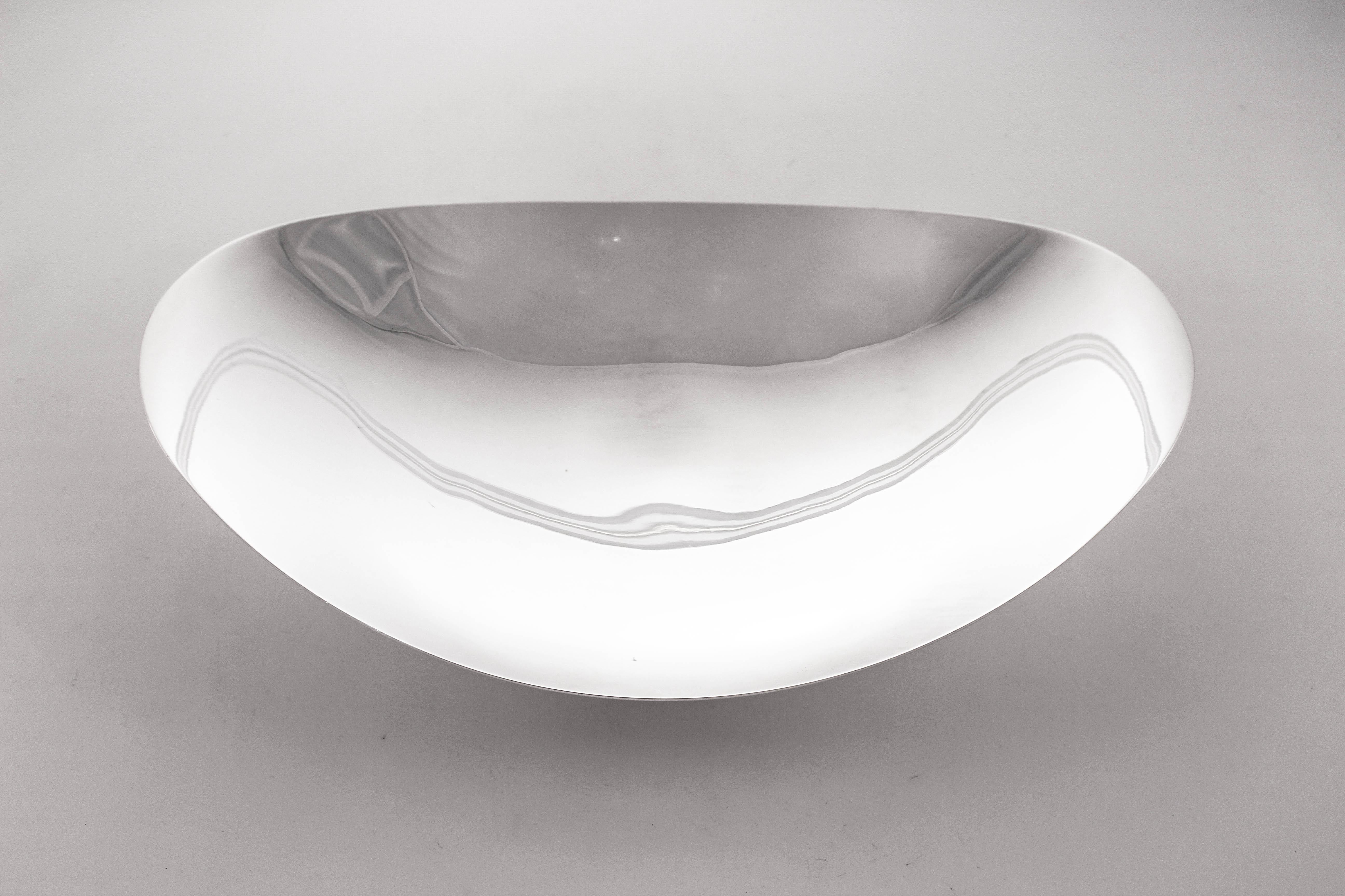 We are so happy to offer this sterling silver Mid-Century Tiffany dishes. It has an oval shape and curves upwards on the ends. It stands on a pedestal (not weighted) thereby off the surface. It has an that uber-sleek midcentury look that Tiffany was