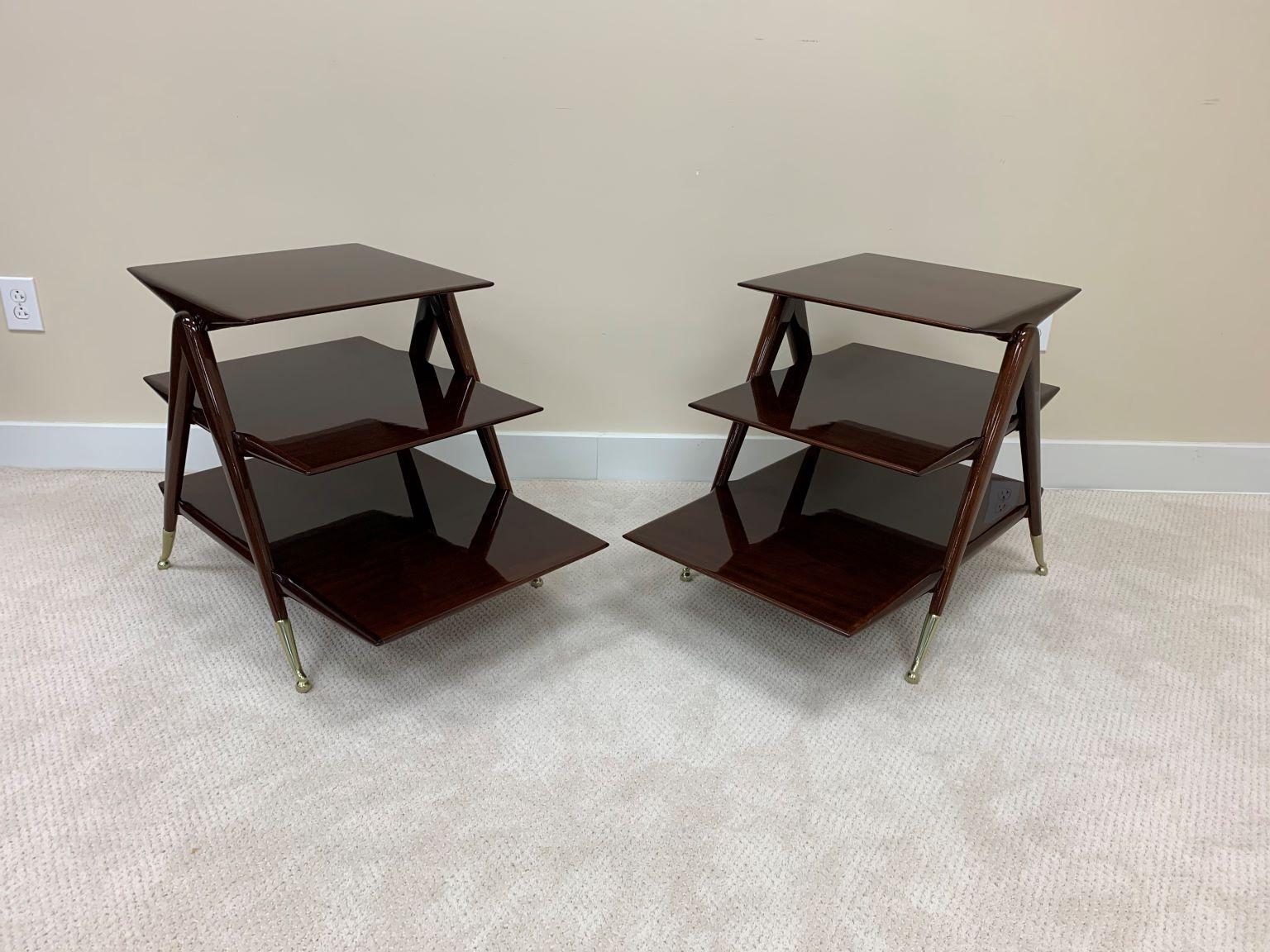 Incredible pair of mid century side tables in the style of Ico Parisi. The tables have three-tiered shelves of graduated lengths supported by an inverted-v leg. The walnut has been beautifully restored in a gloss finished accented with re-polished