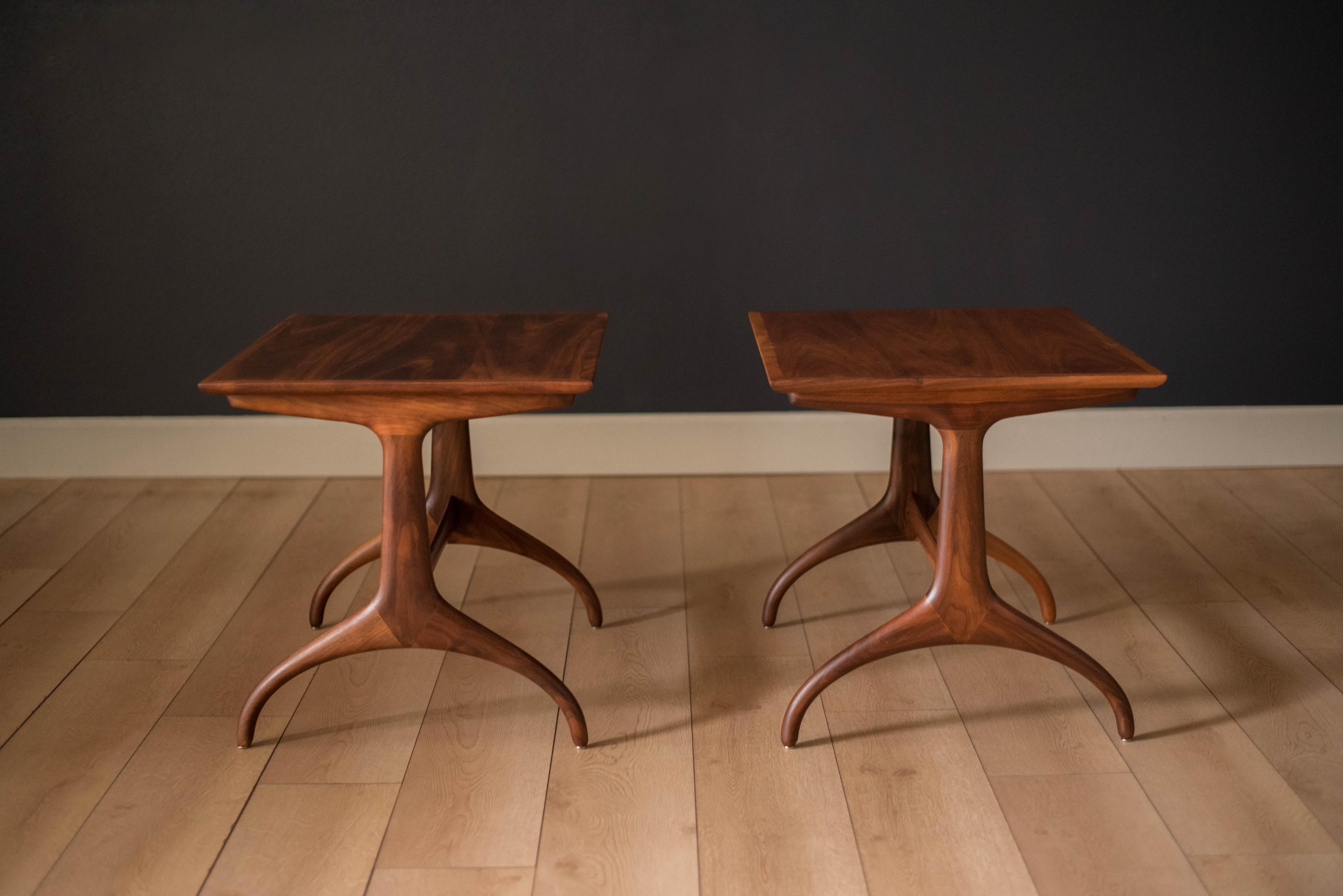 Vintage pair of side tables in walnut by Heritage Henredon, circa 1960s. This classic set features a rectangular shaped top with sculptural wishbone legs. Perfect for any Mid-Century Modern or contemporary decor. Price is for the pair.


Offered by