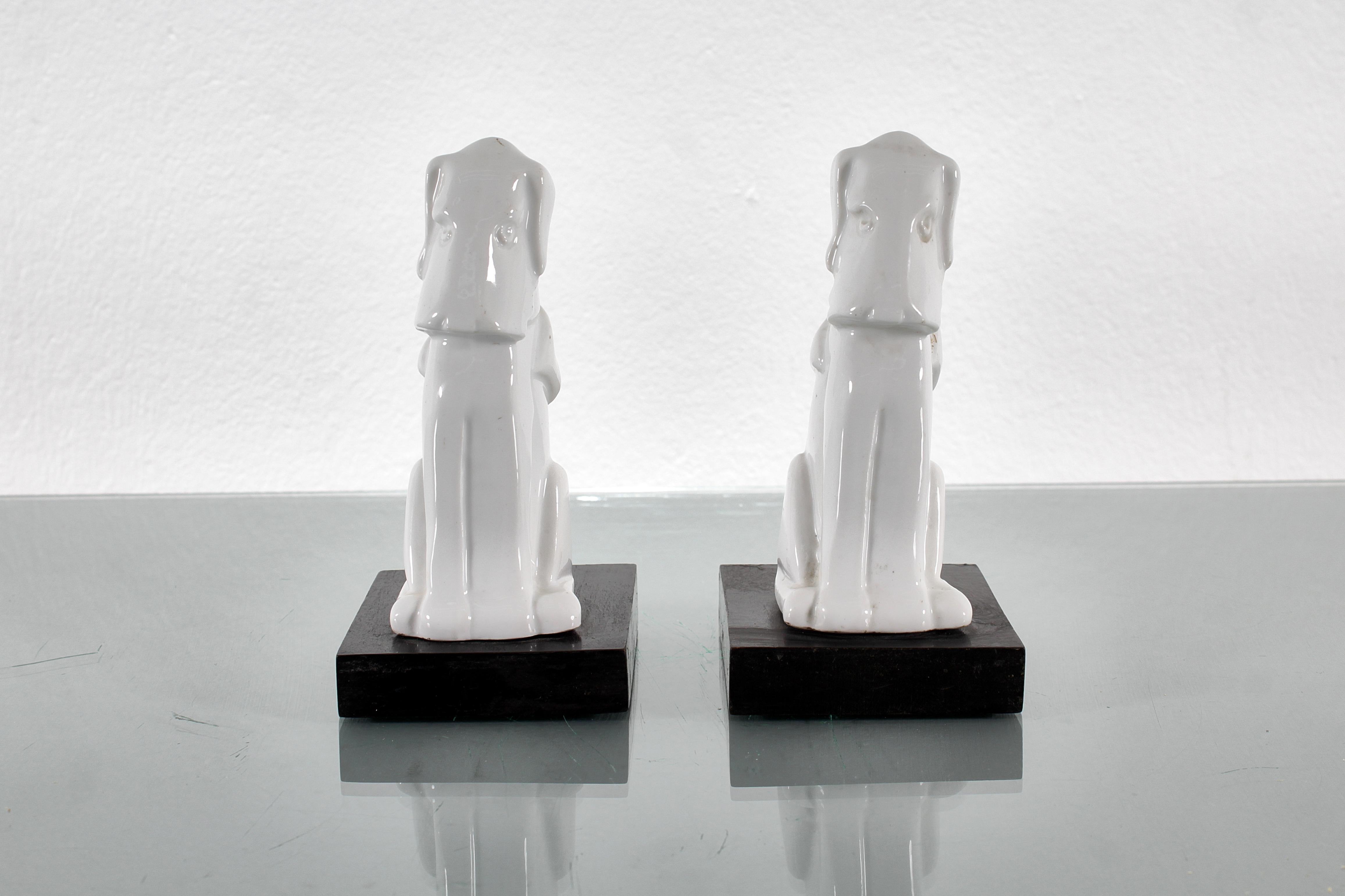 Pair of white porcelain dogs, on black lacquered wooden stand. Italian production, 1970s.
Wear consistent with age and use.