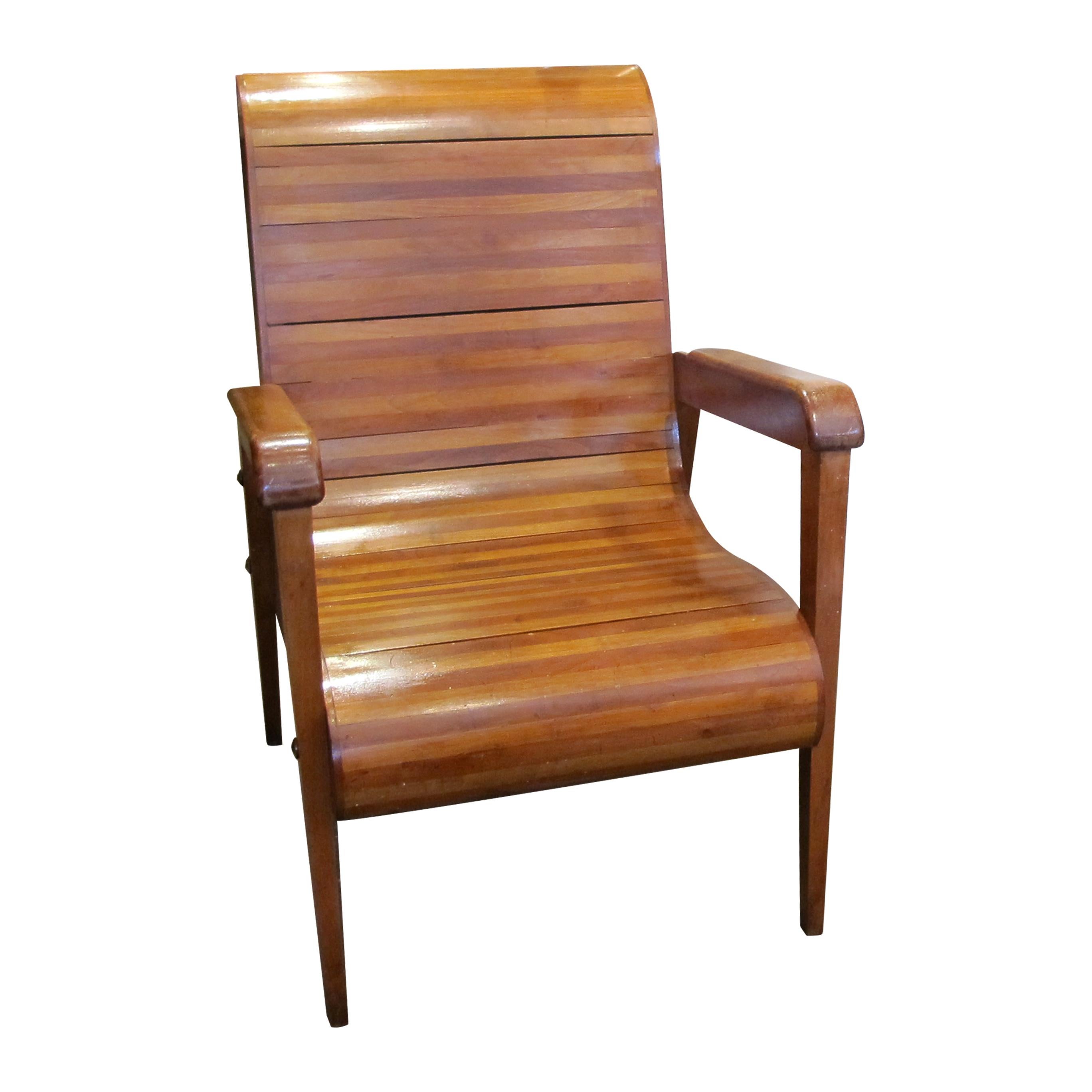 These elegant handmade pair of 1950s armchairs made in Italy feature a classic slatted wood design that combines form and function beautifully. The chairs boast gently curved backrests and seat panels, composed of smooth, horizontally arranged