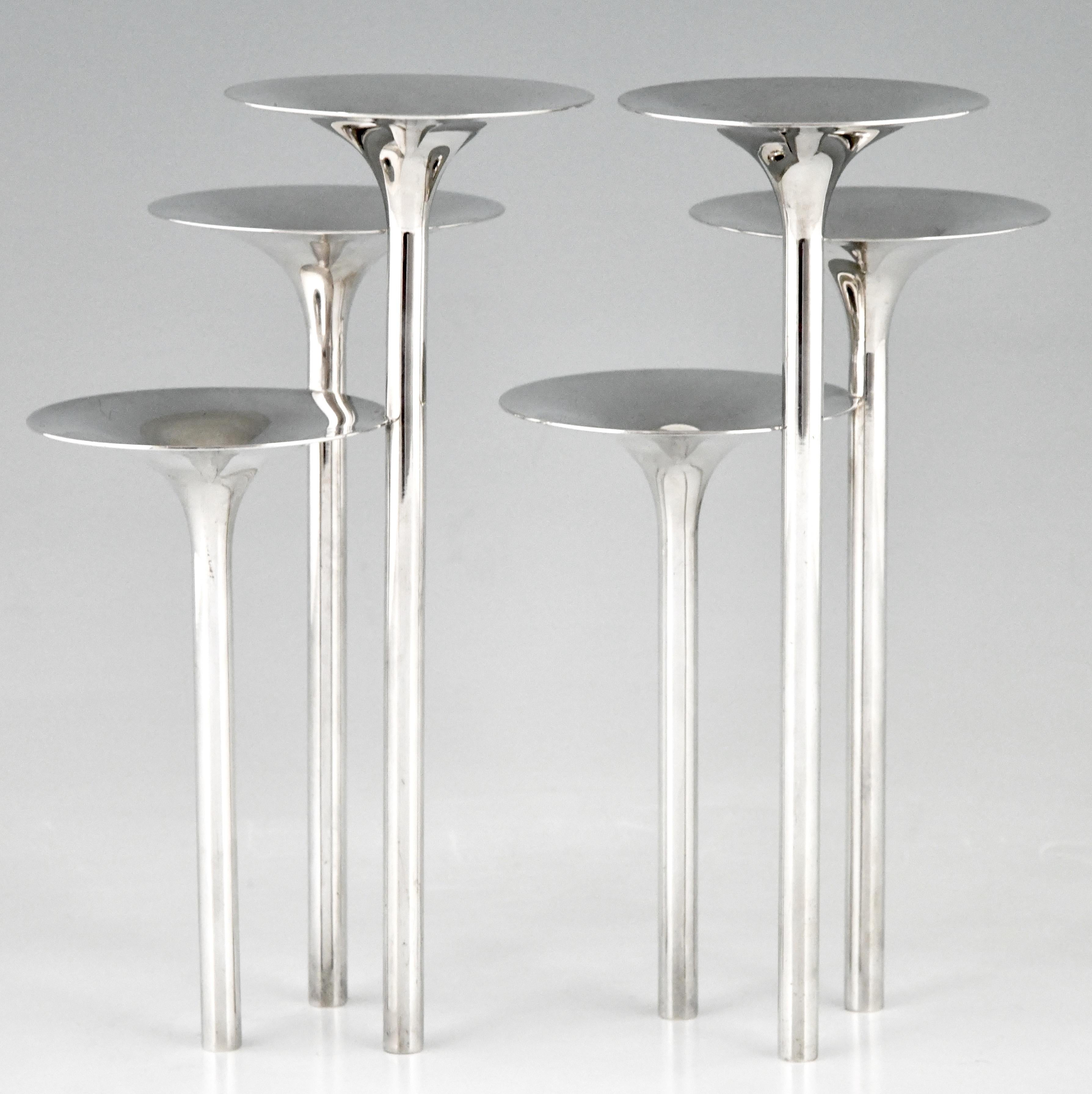 Mid-Century Modern pair of silvered flower stands or candleholders.
Portafiori Concerto Di Trombe designed by the Italian designer Lino Sabattini for Gallia, Christofle, 1957. 

This model is illustrated in ?“Il design Italiano degli anni ’50”