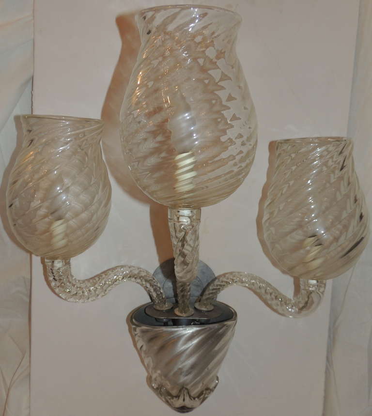 A wonderful large pair of Venetian art glass three arm wall sconces. This pair is circa 1920s, but has todays modern transitional look.