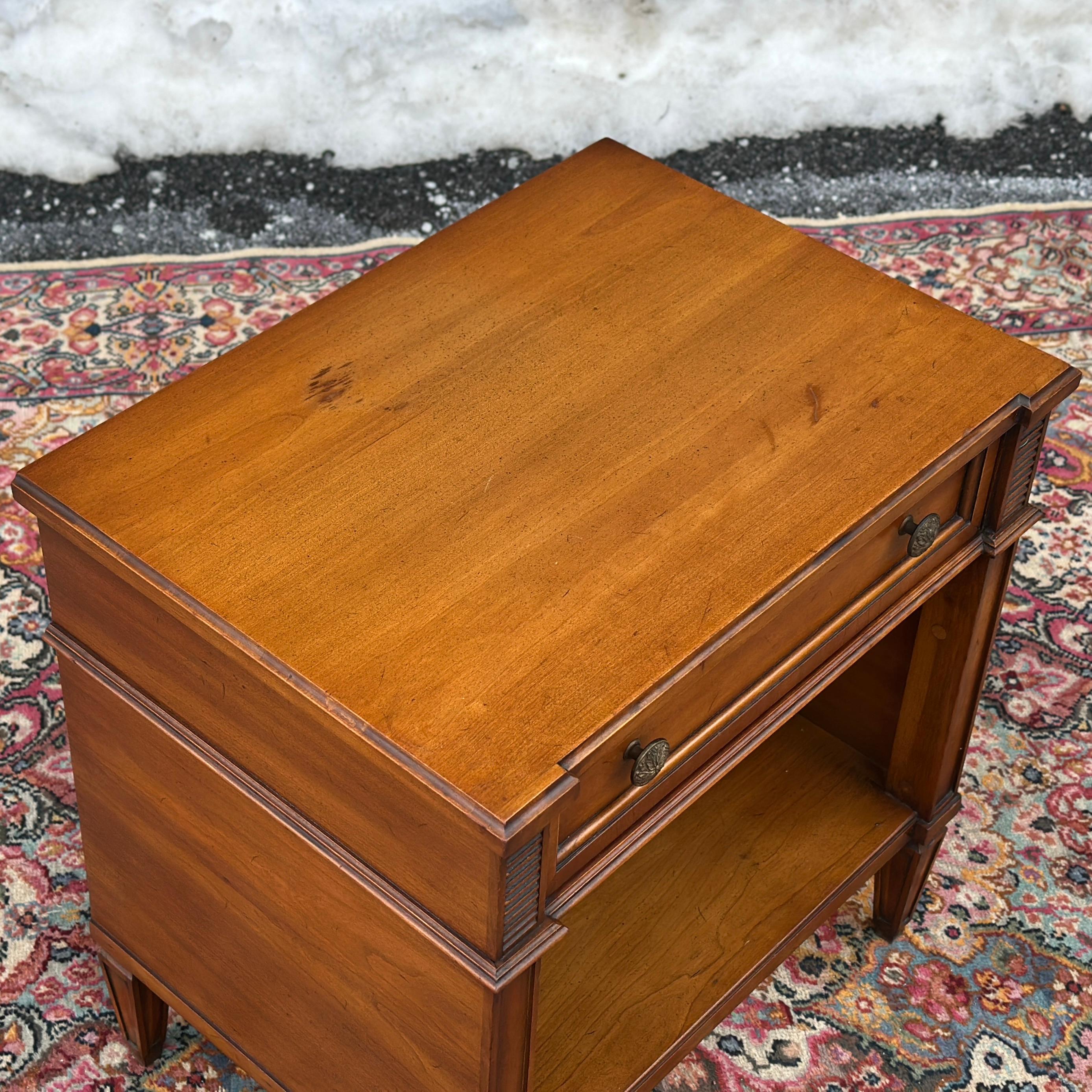 High quality mid-century bedside table from the Palazzo series by Drexel featuring a single dovetailed drawer with decorative brass hardware above open storage area. Signed inside drawer and on backside.