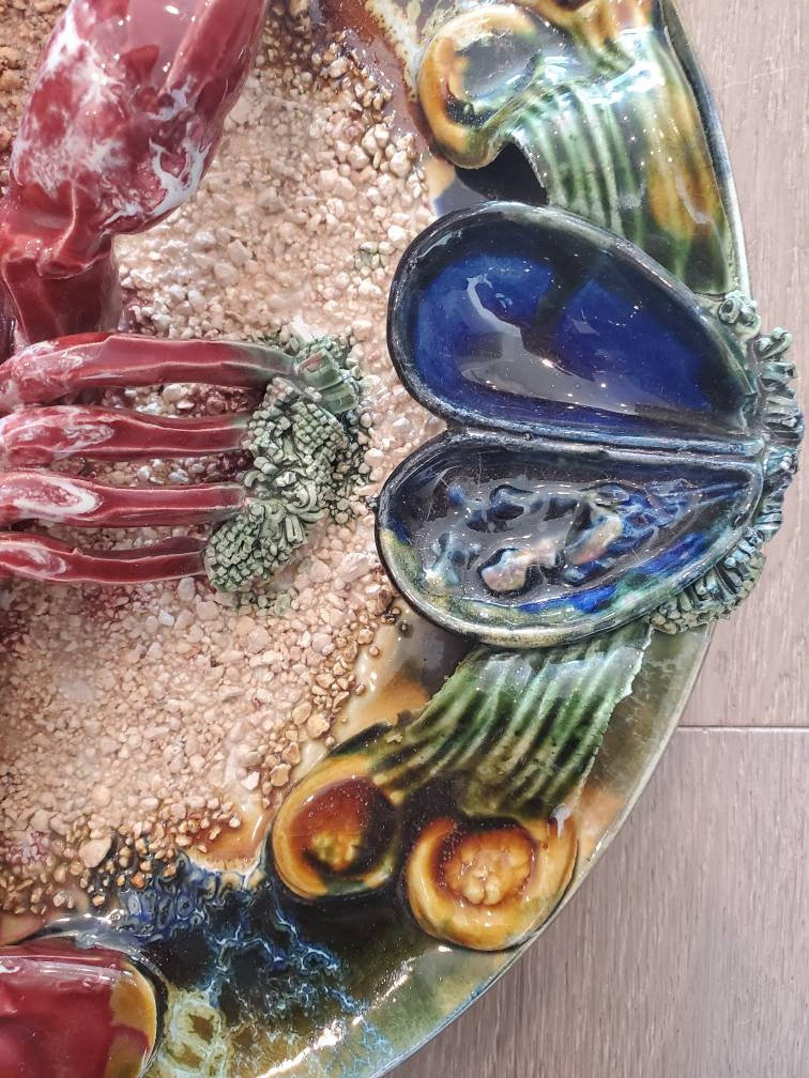 A large and wonderfully decorative Palissy ware style Majolica faience ceramic Lobster platter wall sculpture. 

Mid-20th century, Portugal, decorated in relief with large central lobster, mussels, seaweed, sand, sea-shells, and other applied