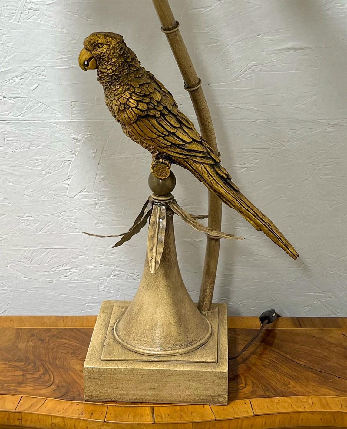 This is a pair of Palmbeach Regency style tole parrot lamps. The body of the bird is composition, and the bases and palm fronds are metal. The shade is 18”D and 8” in height. The base is 7.5” square. They are in very good condition and have vintage