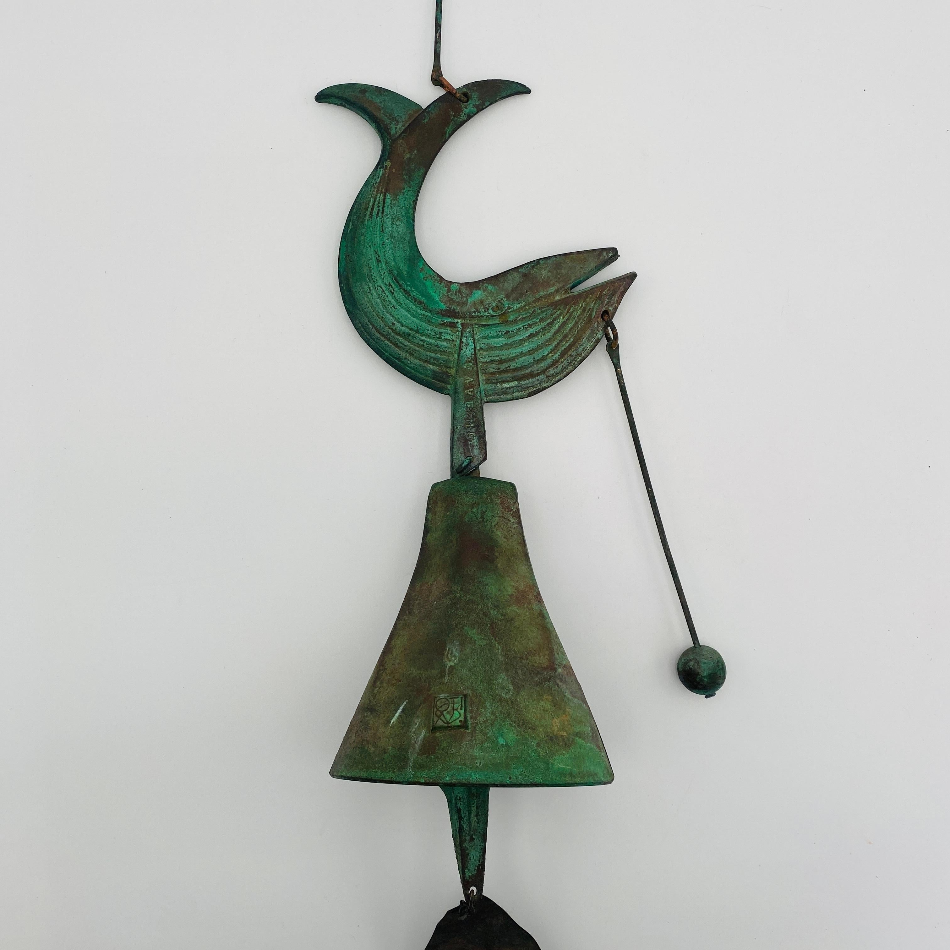 This bronze bell was designed by Paolo Soleri, as part of the *Save The Whales* conservation movement against whaling in the 1980's. The bell features the Cosanti hallmark on the side of the bell. The words 